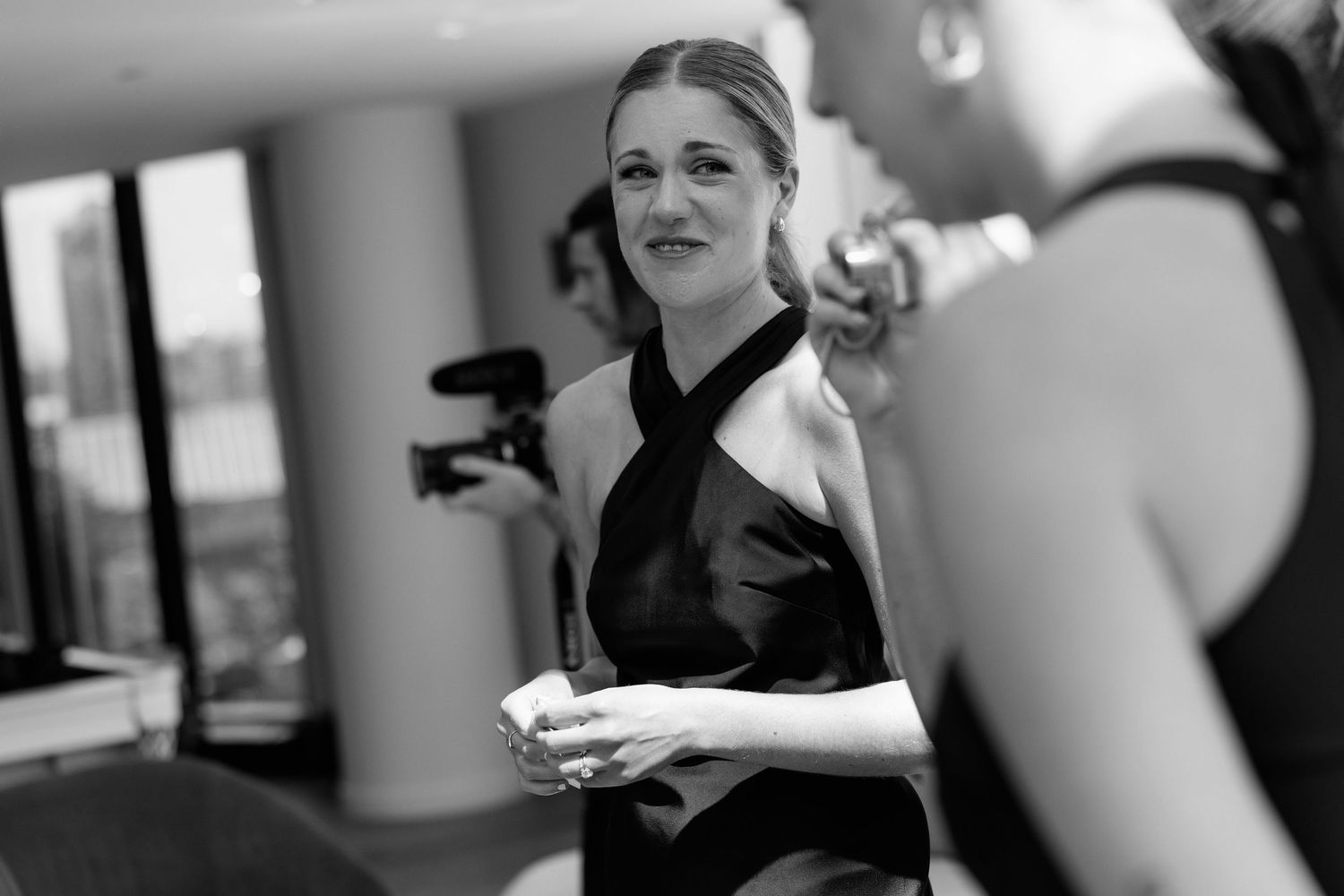 Candid moments captured during a formal event preparation in black and white.