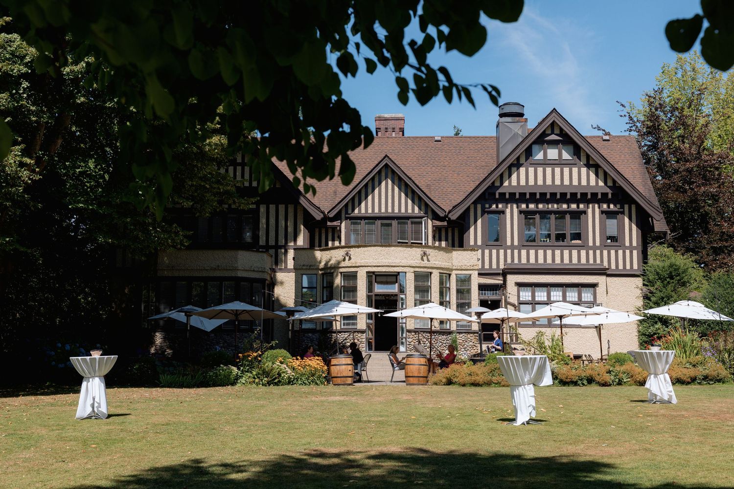 Elegant Tudor-style restaurant with decorative elements on sunny lawn at Hurt House in Burnaby