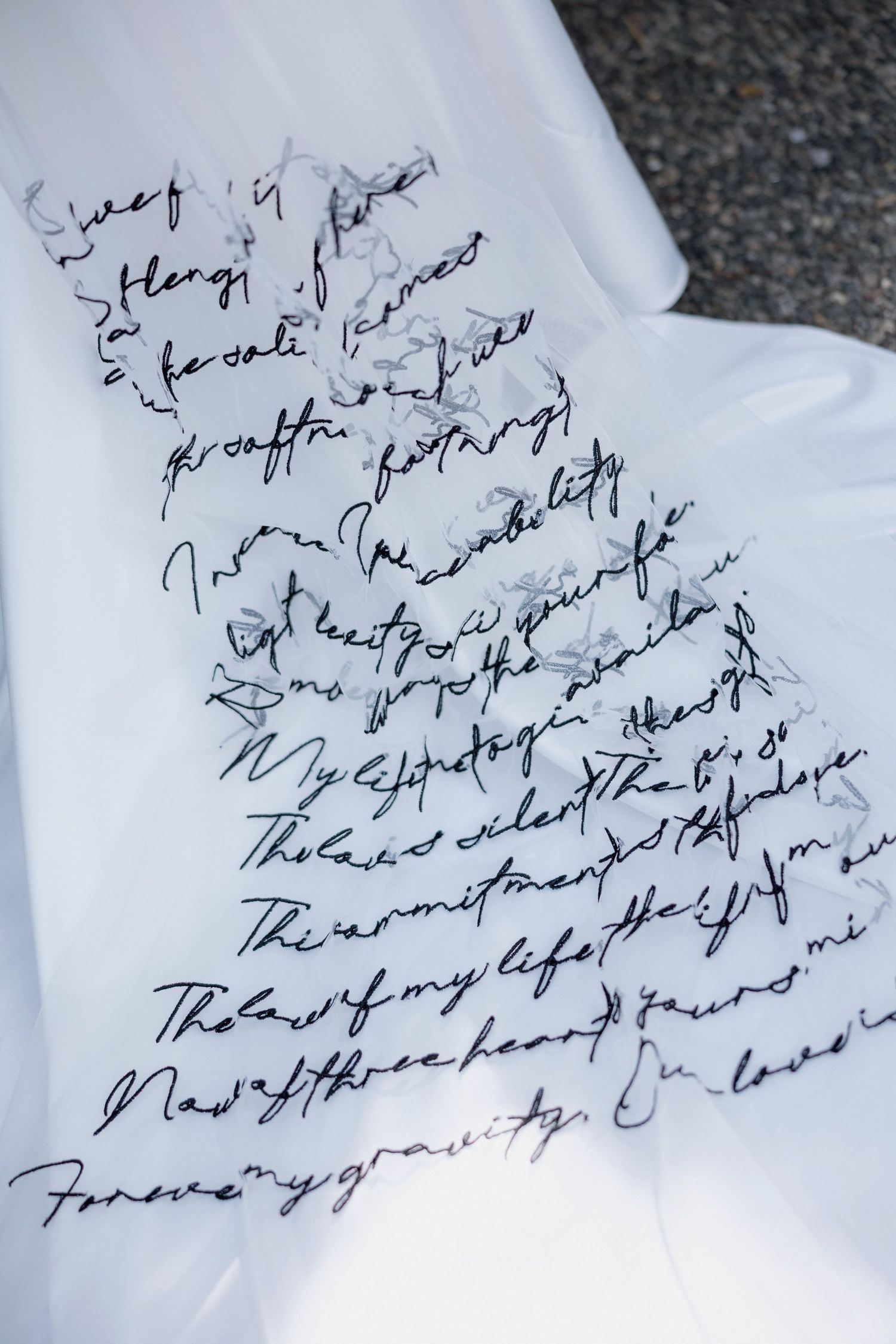 Handwritten cursive text in black ink appears on crumpled white paper with faint writing visible in the background.