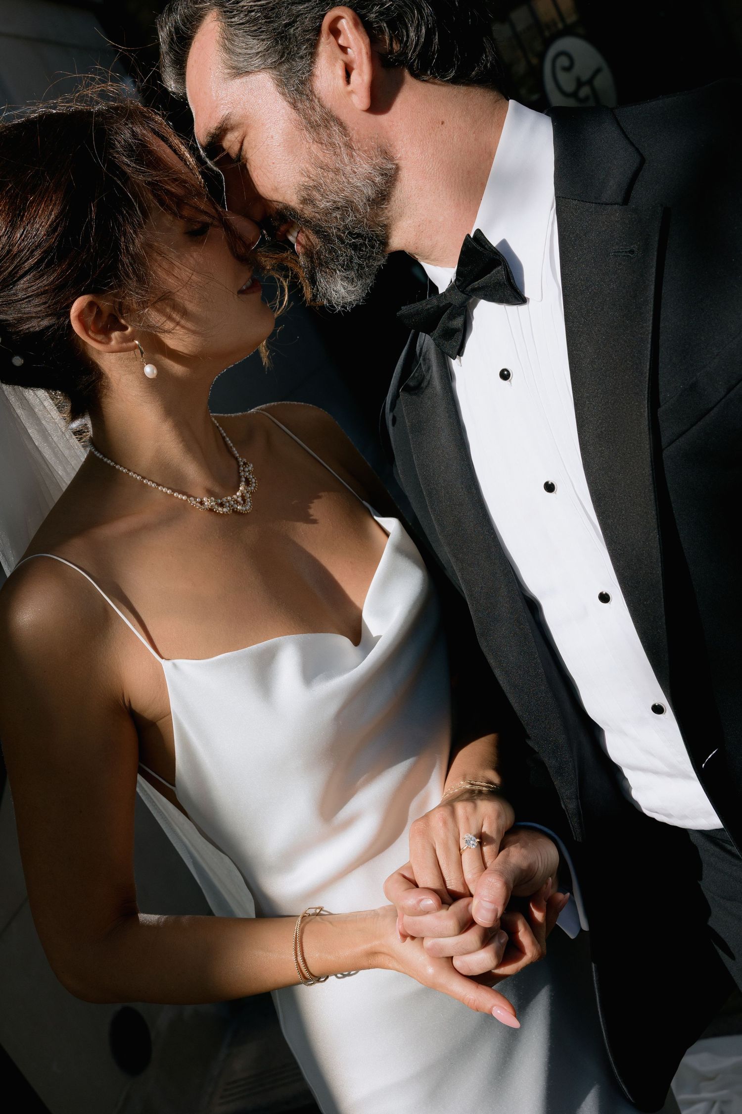 Dramatic black and white wedding portraits capturing intimate moments between newlyweds.