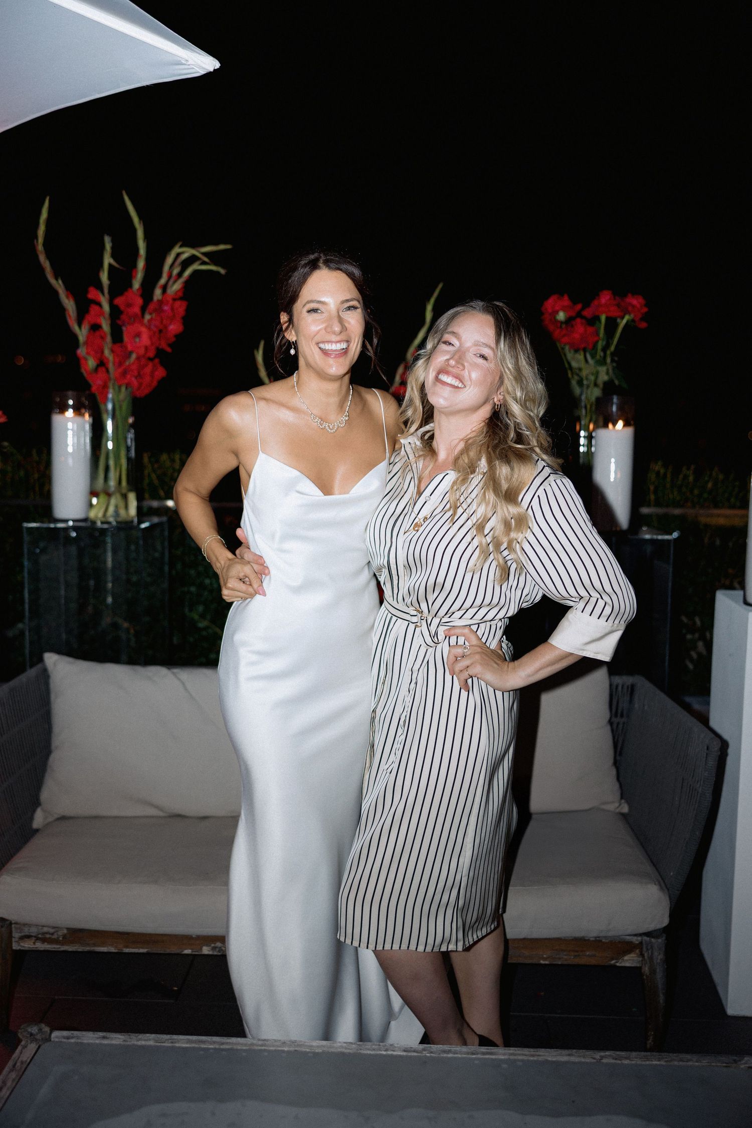 Evening celebration on an outdoor terrace with decorative lighting and floral arrangements in the night of Vancouver