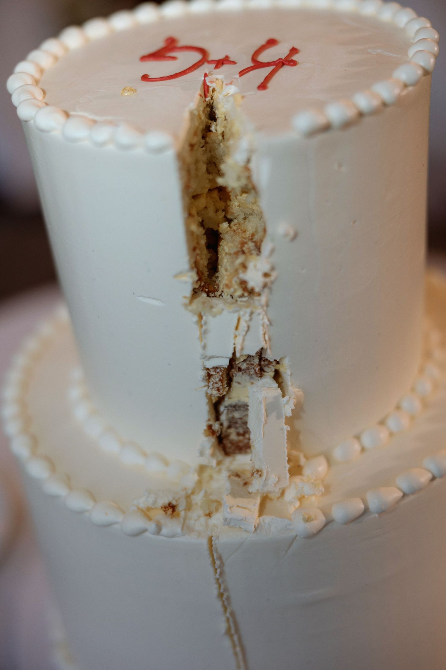 Close-up shots of a white wedding cake showing cut pieces.