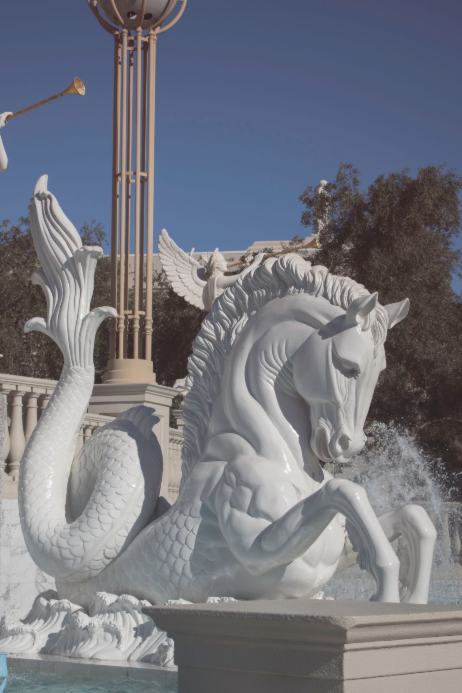 White marble hippocampus fountain sculpture with water splashing at Caesars Palace Las Vegas.