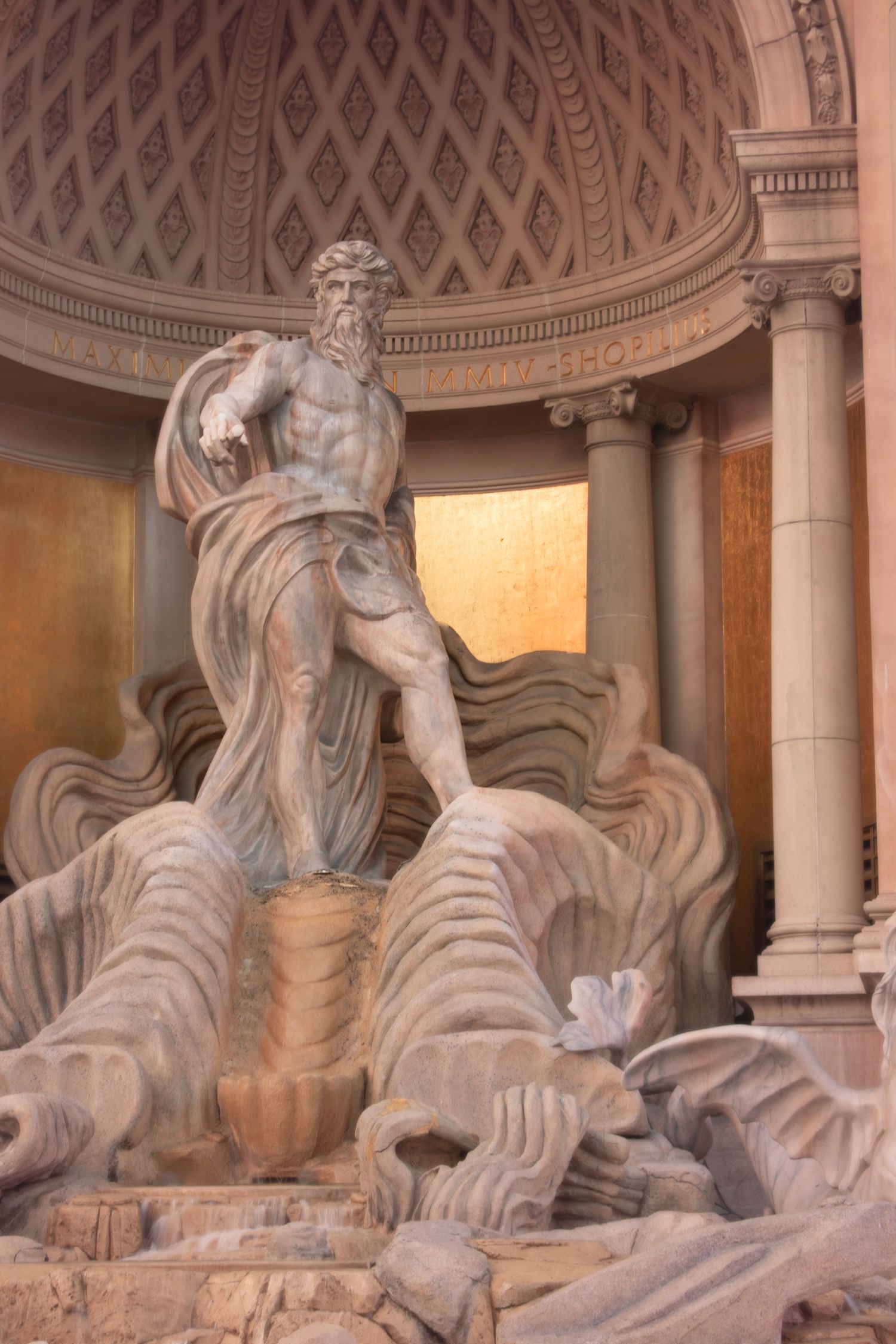 Classical marble statue of Neptune in a grand domed architectural setting with ornate columns.