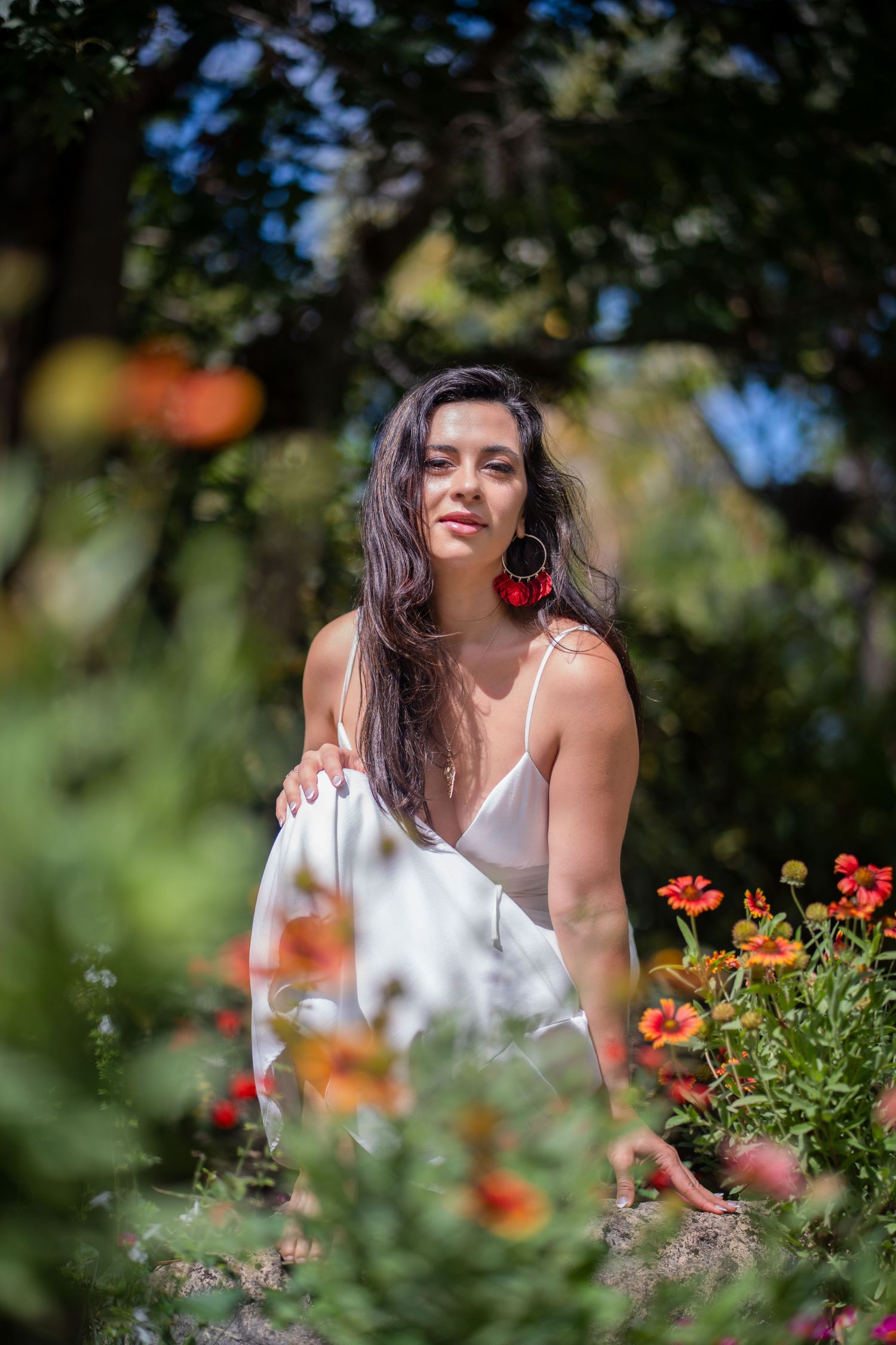 Miami portrait session of woman in white dress framed by flowers in botanical garden