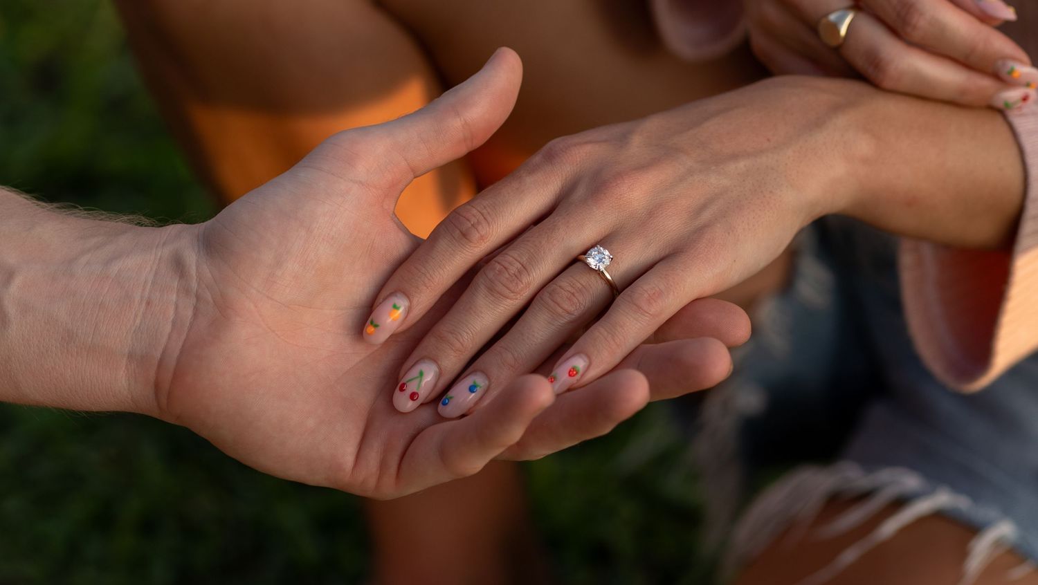 Close-up engagement photo of hands showing a newly placed ring during a beach proposal in Key Biscayne.