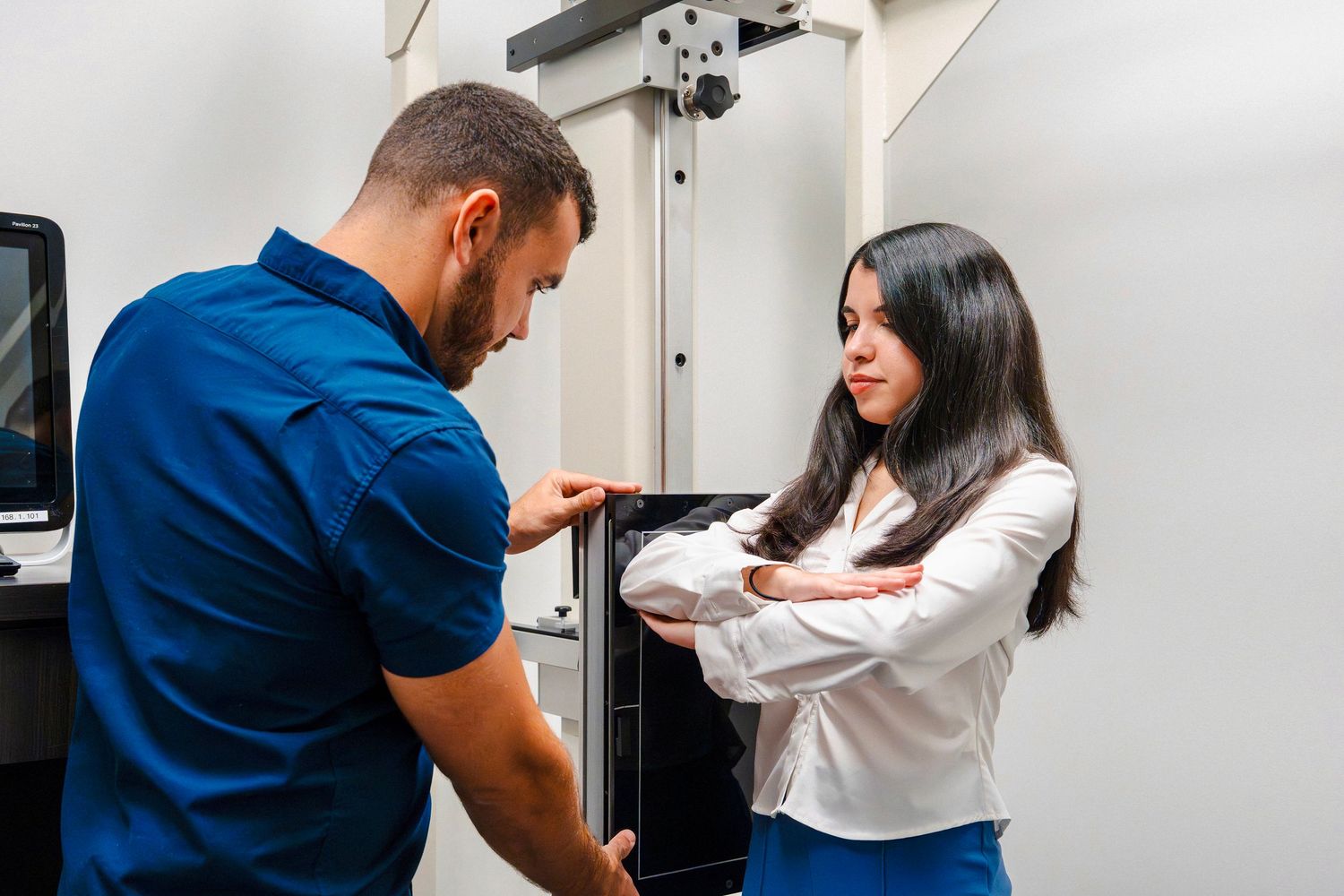 Chiropractor examining female patient’s arm inside treatment room during lifestyle branding session