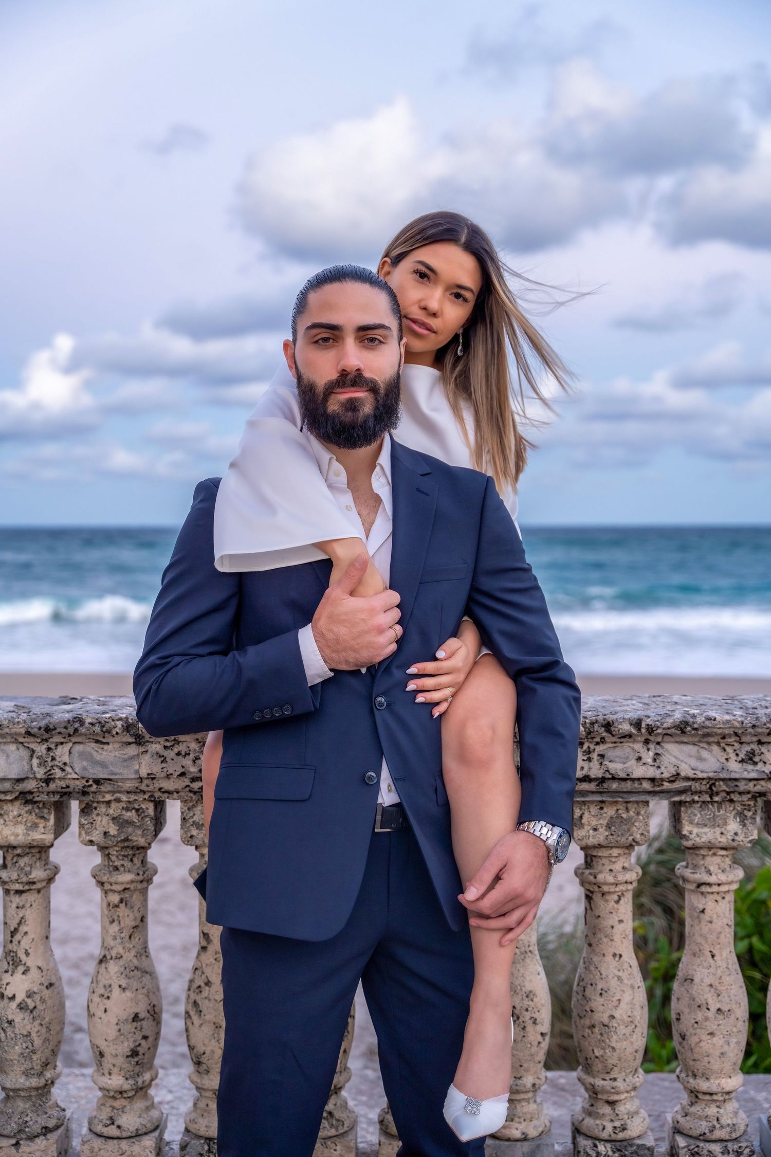 Elegant engagement session by the ocean, capturing timeless romance with a breathtaking waterfront view.