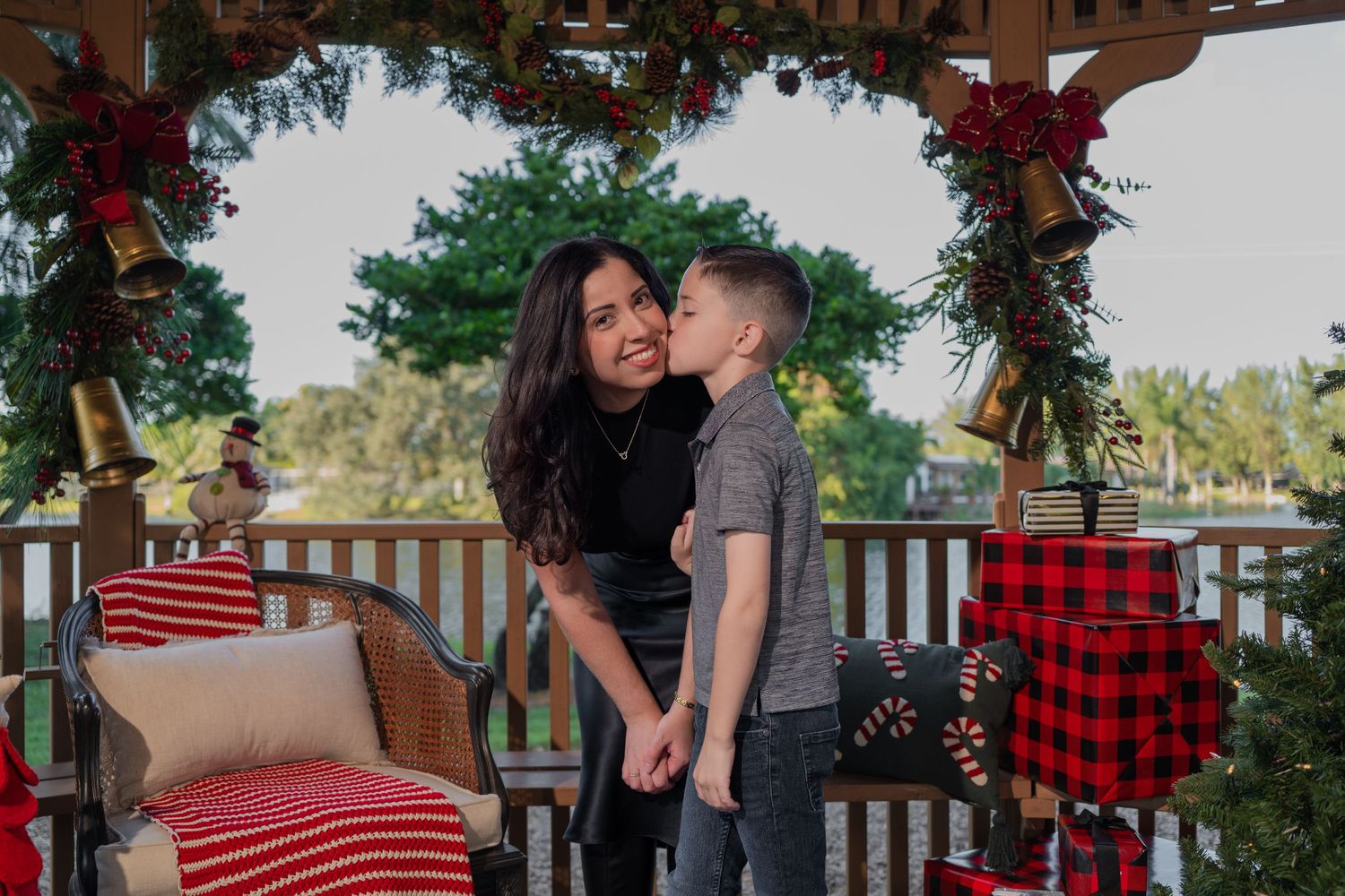 Sweet mother-son holiday portrait in Hollywood, FL – Christmas mini session with festive decorations and warm smiles.