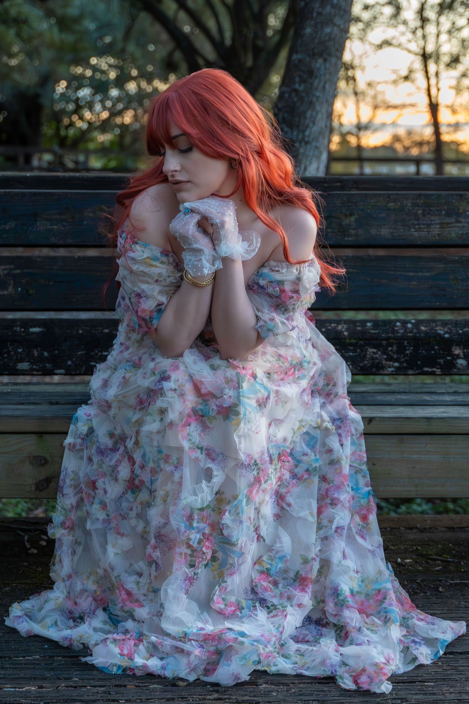 Timeless elegance – dreamy outdoor portrait of a red-haired woman in a delicate floral dress, lost in thought. Amelia Earhart Park