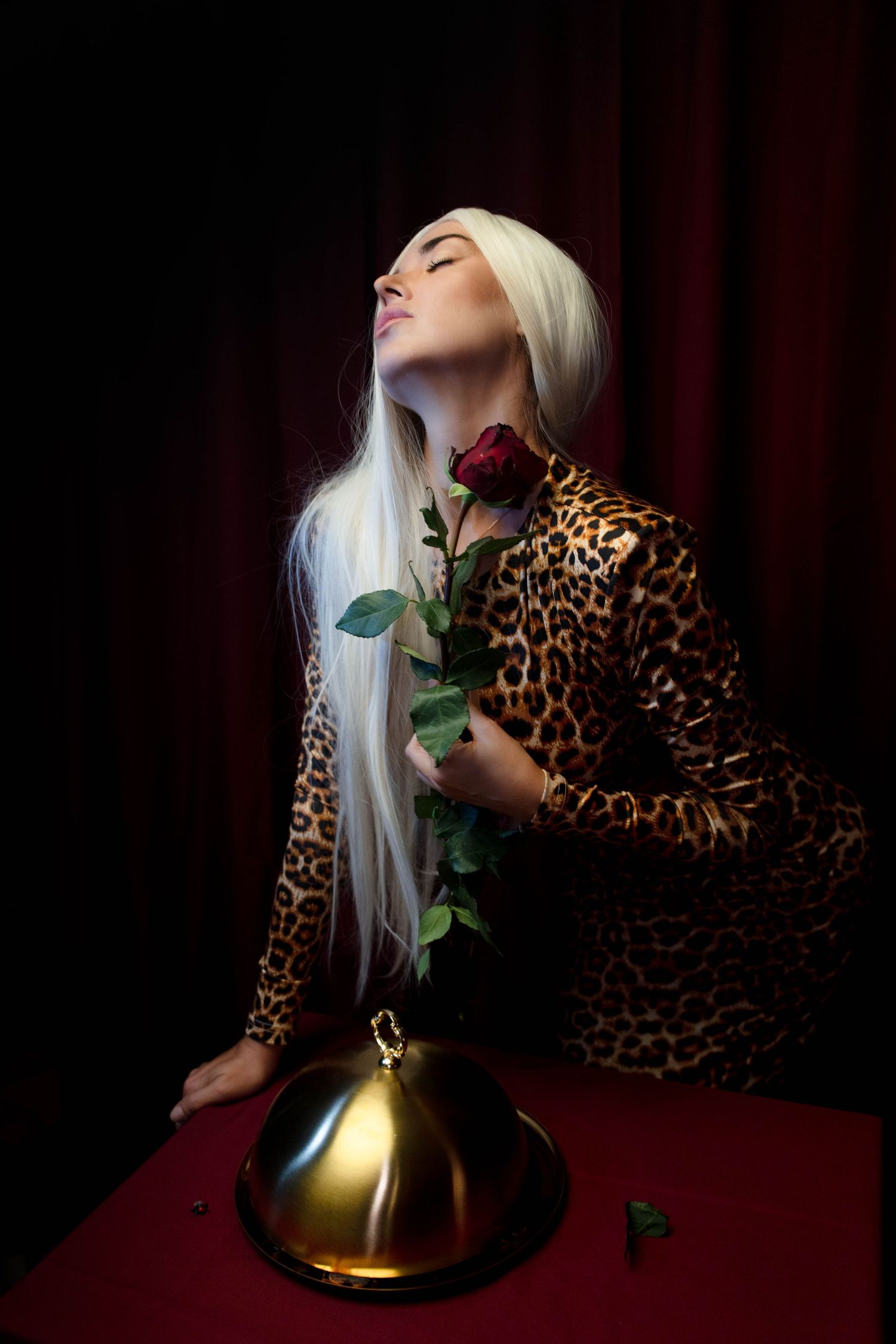 Luxury fashion portrait in Boca Raton, FL – avant-garde styling with a rose and dramatic lighting.