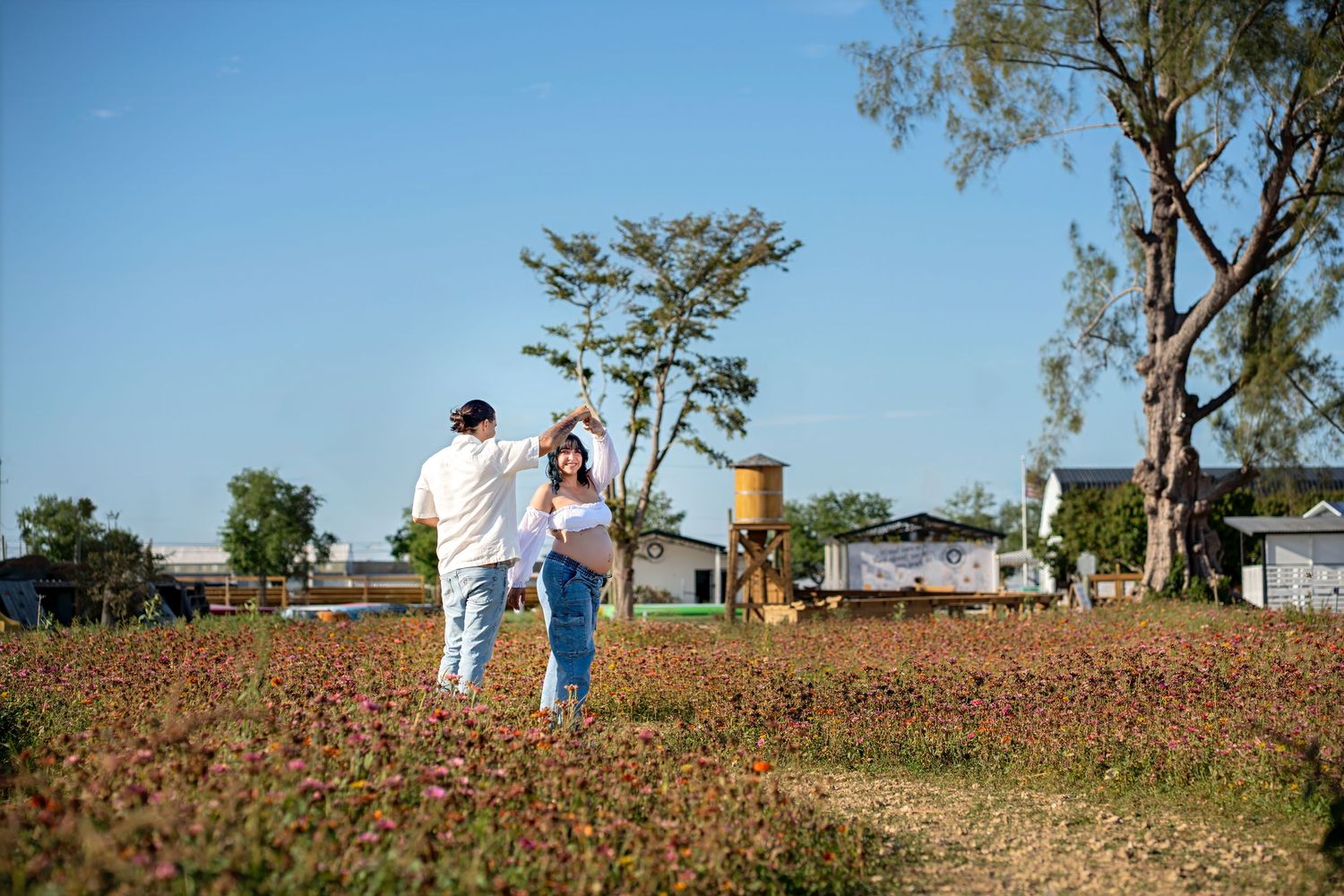 Walking maternity photo in open field at Berry Farms, South Florida.