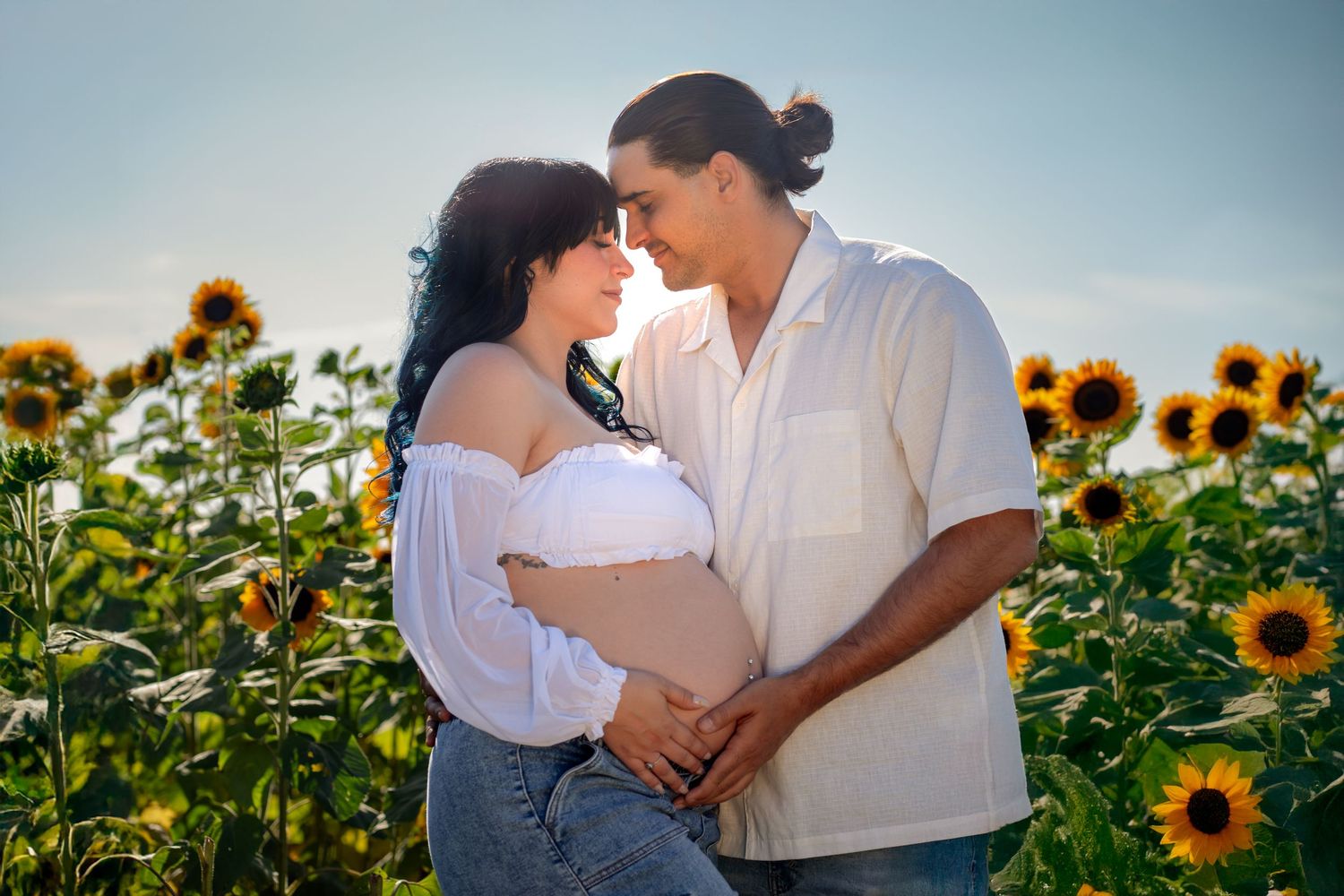 Maternity photos at Berry Farms in Miami by South Florida photographer, couple in sunflower field with soft golden light