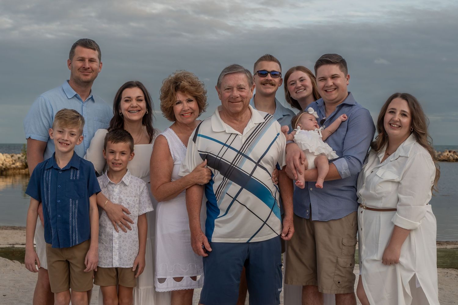 Extended family photoshoot in Key Largo, FL – three generations celebrating together at a scenic park near the water.