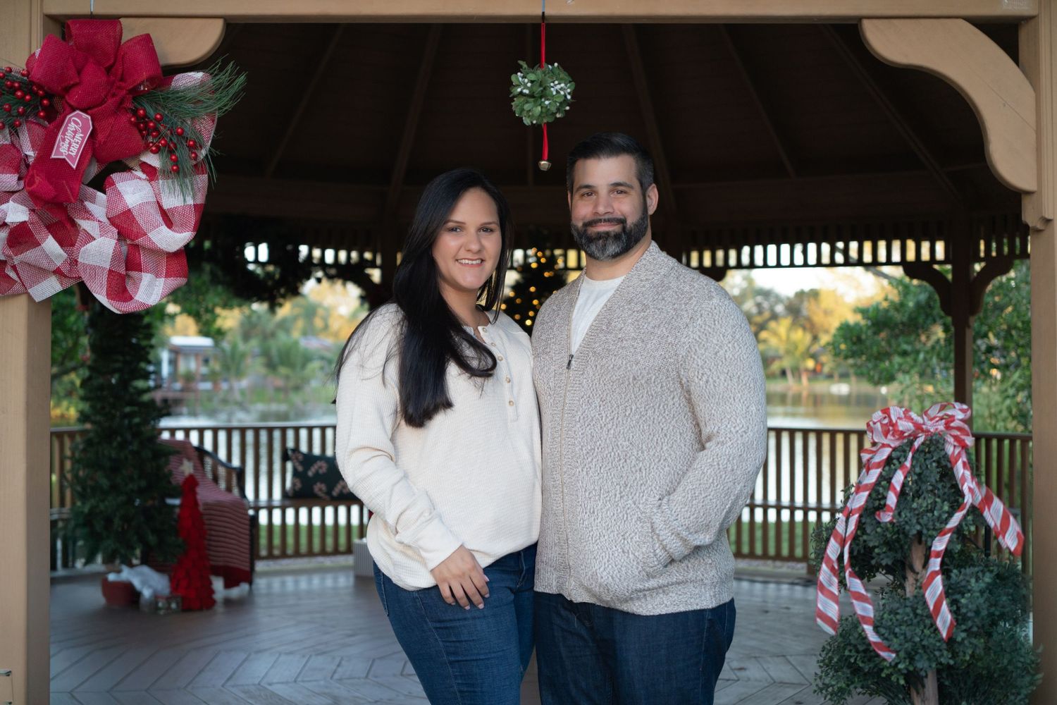 Romantic holiday couple session in Pembroke Pines, FL – sweet moment under mistletoe with Christmas decorations.