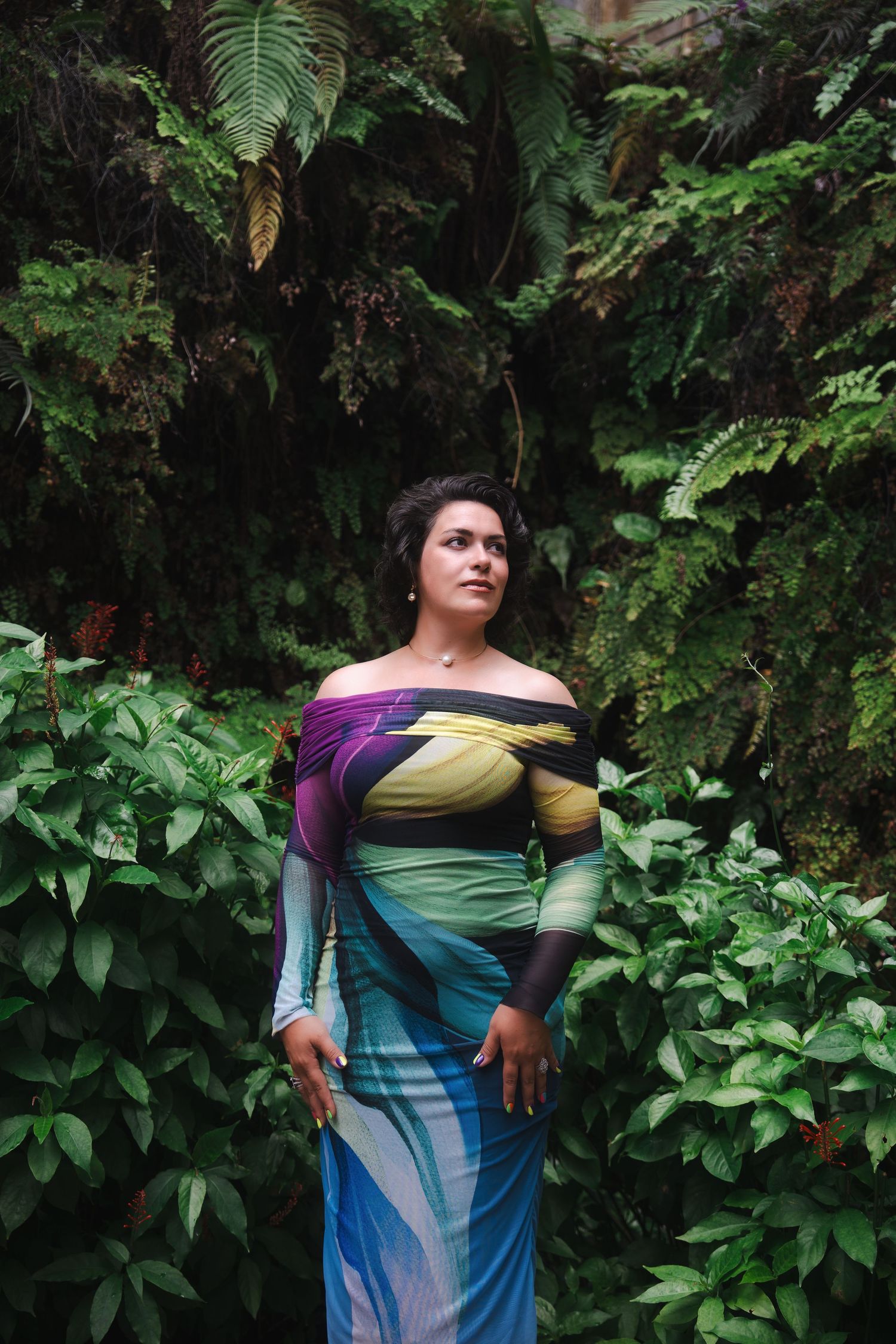 Full-body branding photo of a woman standing confidently in lush greenery during a Fairchild Garden branding session.