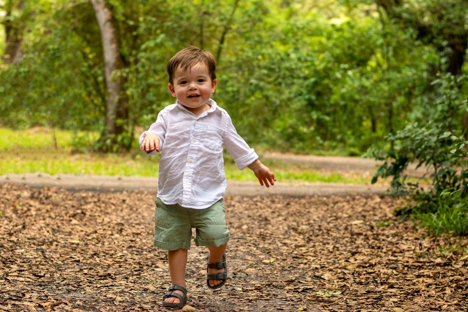 Toddler running through nature at Tree Tops Park, Davie, FL – joyful childhood moment surrounded by lush greenery.