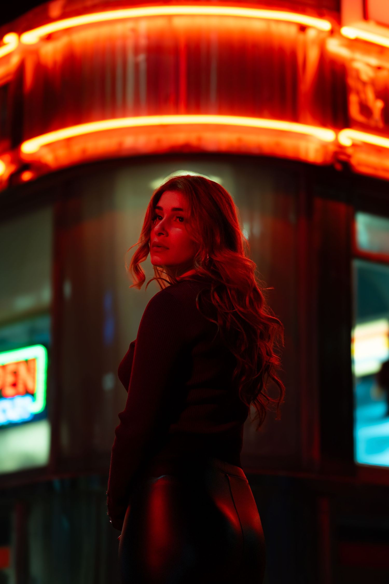 Cinematic urban portrait with neon red light, shot in Fort Lauderdale by a portrait photographer.