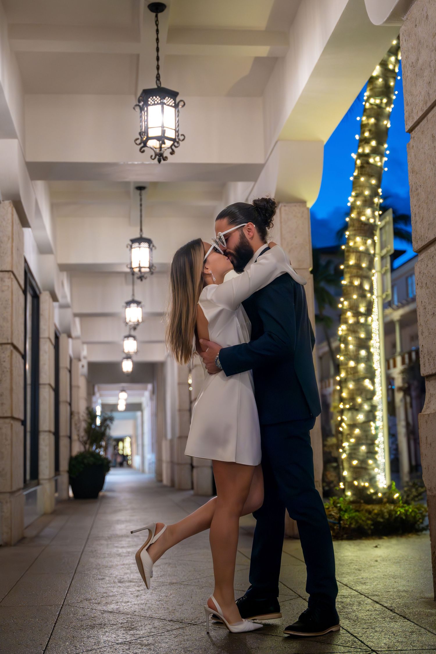 Elegant engagement portrait on Worth Avenue, capturing romance under soft evening lights and classic Palm Beach architecture.