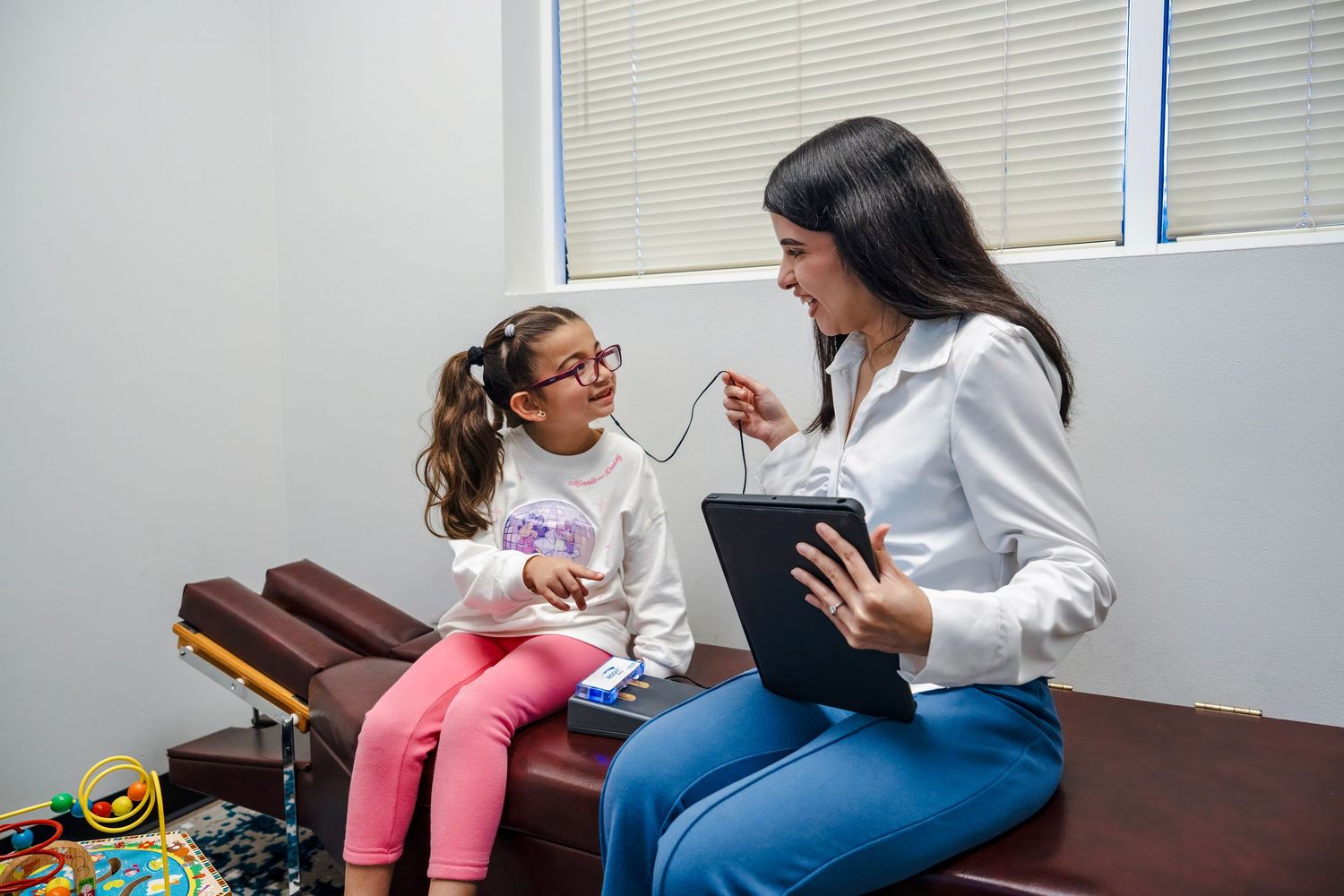 Chiropractor consulting with child patient during branding session