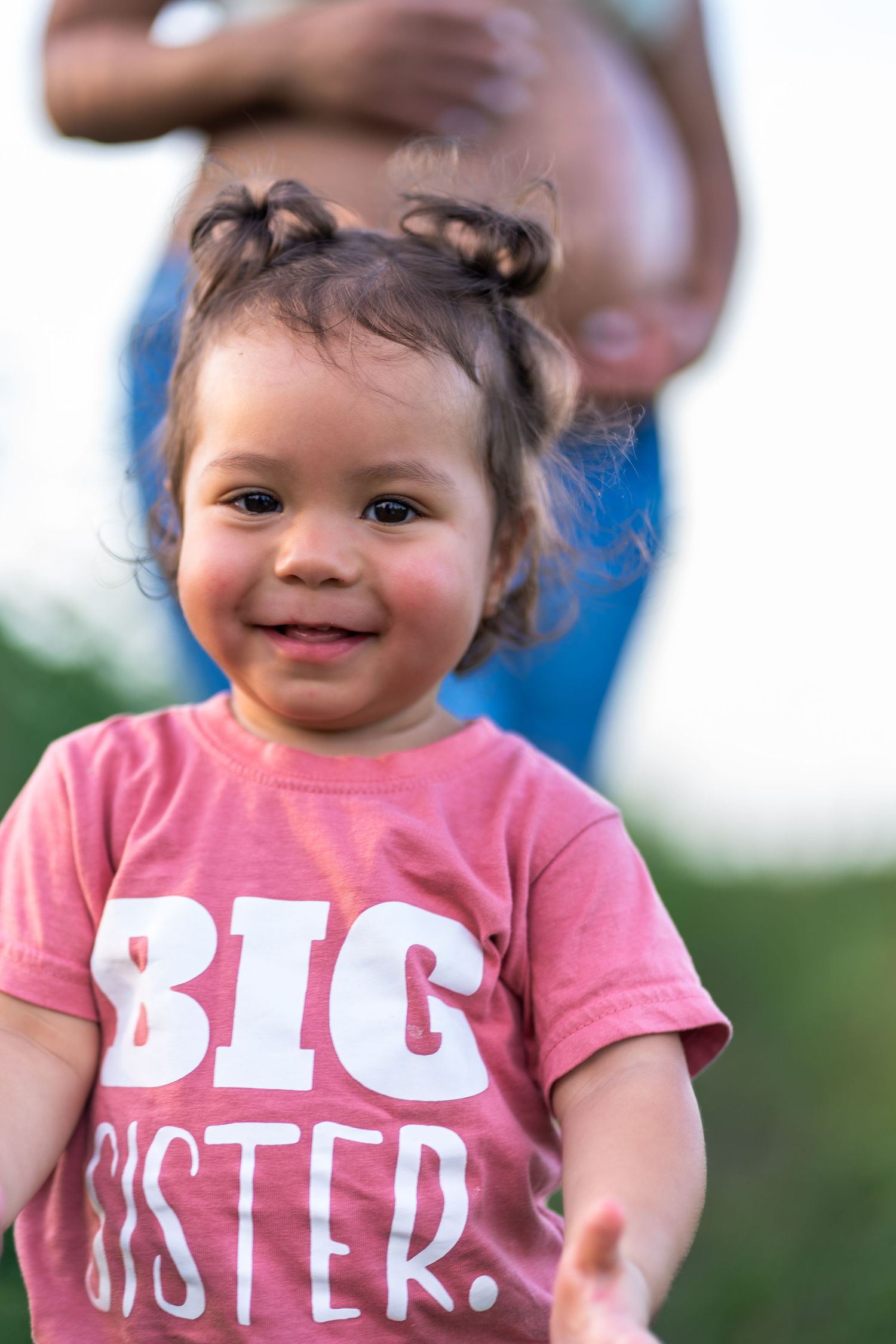 Adorable announcement portrait in Homestead, as a little girl wears a “Big Sister” shirt to celebrate her growing family.