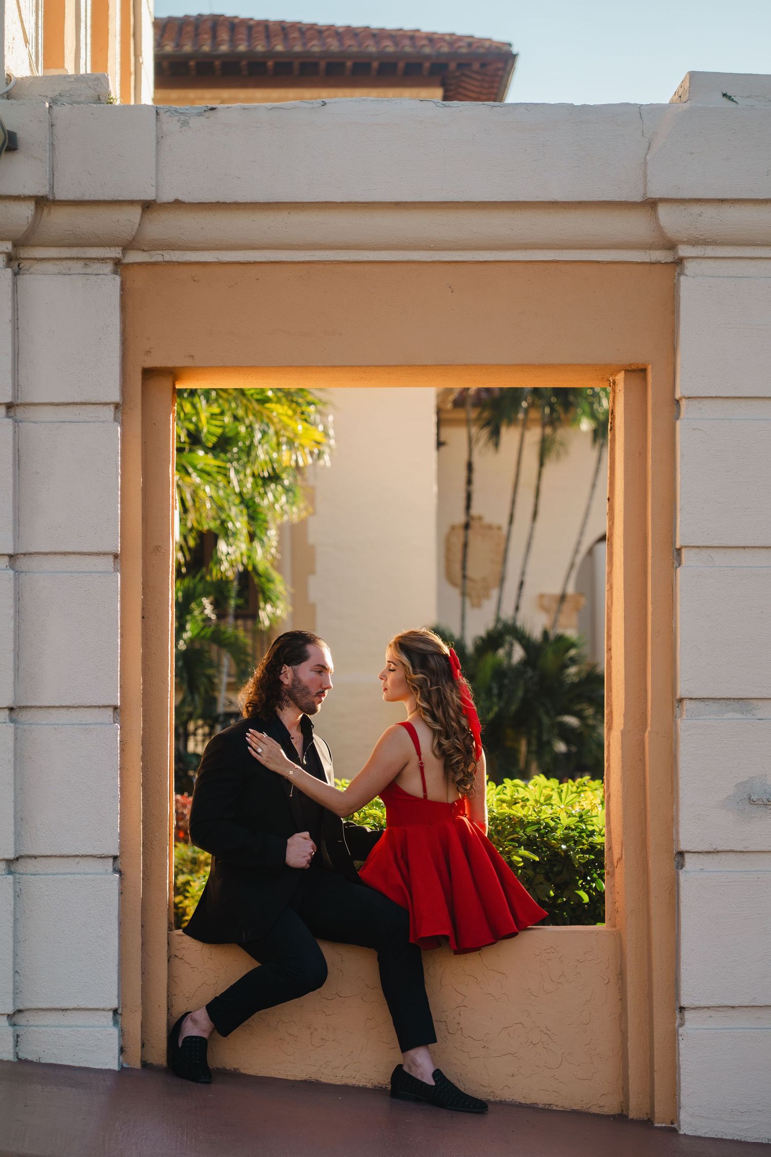 Surprise proposal moment captured in a guided photography experience with couple framed in elegant South Florida architecture