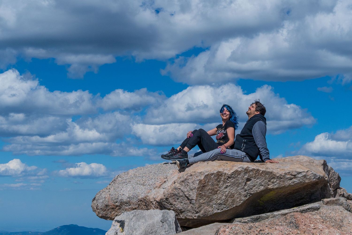 Breathtaking adventure session at Mount Evans, Colorado, capturing a couple enjoying panoramic mountain views.
