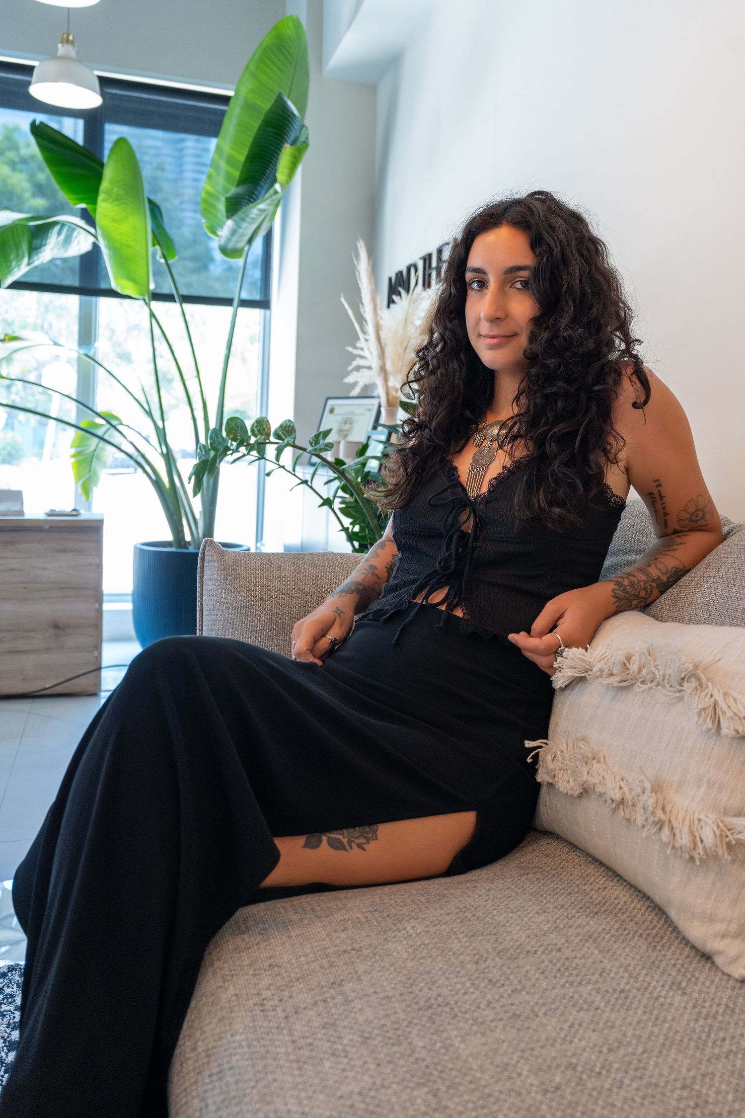Stylish lifestyle portrait in Fort Lauderdale, FL – elegant woman posing in a sleek, plant-filled home setting.