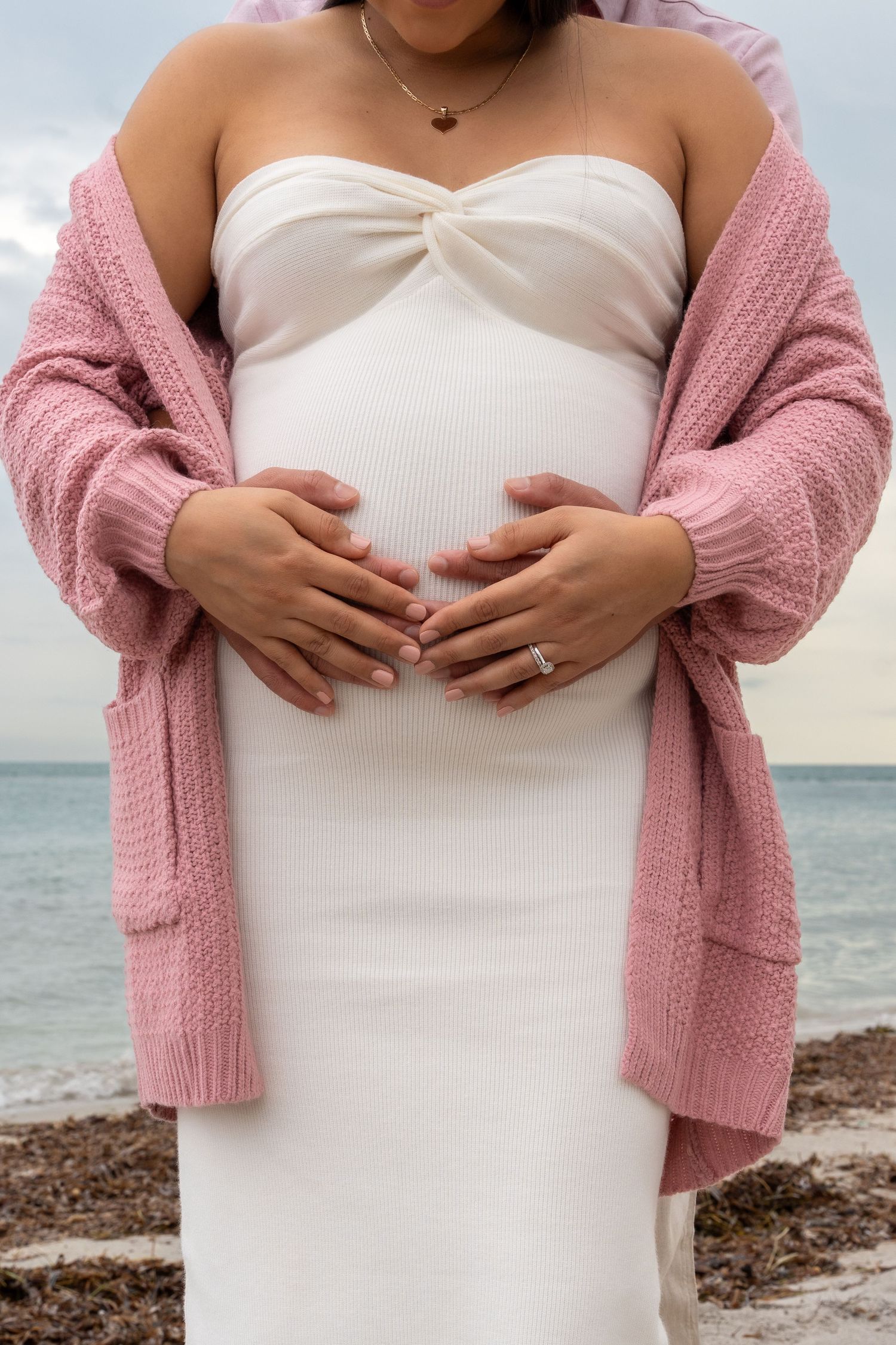 Serene beach maternity portrait in Key Biscayne, capturing a mother-to-be with ocean waves in the background.