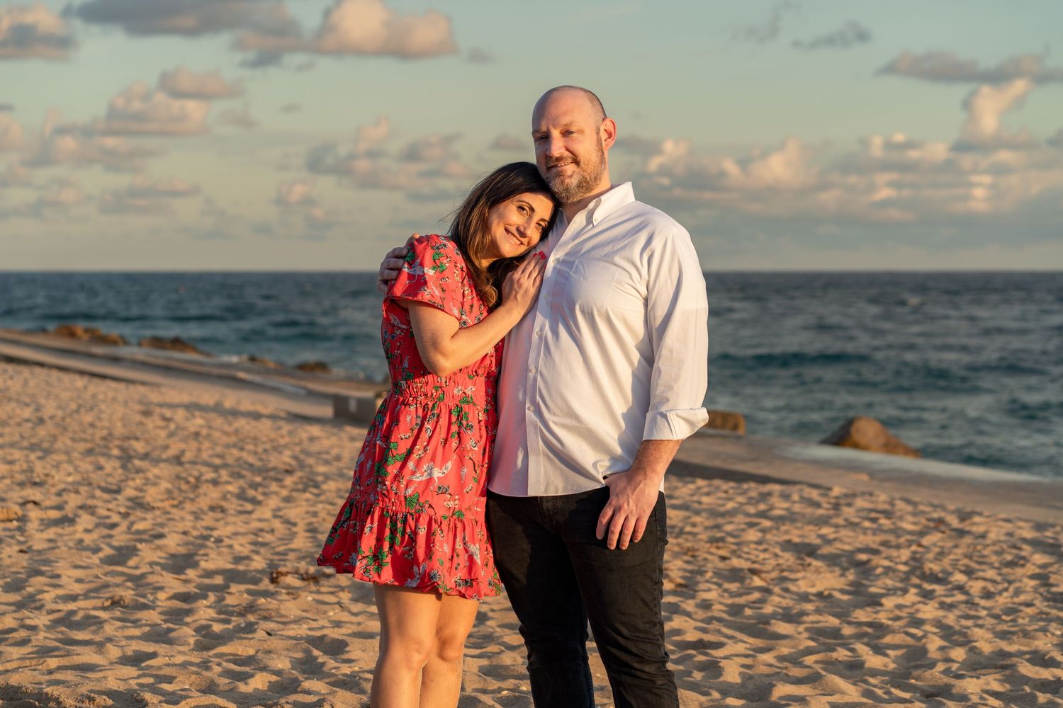 Couple beach photoshoot at sunset in Palm Beach, FL – romantic golden-hour portrait on the sand with ocean backdrop.