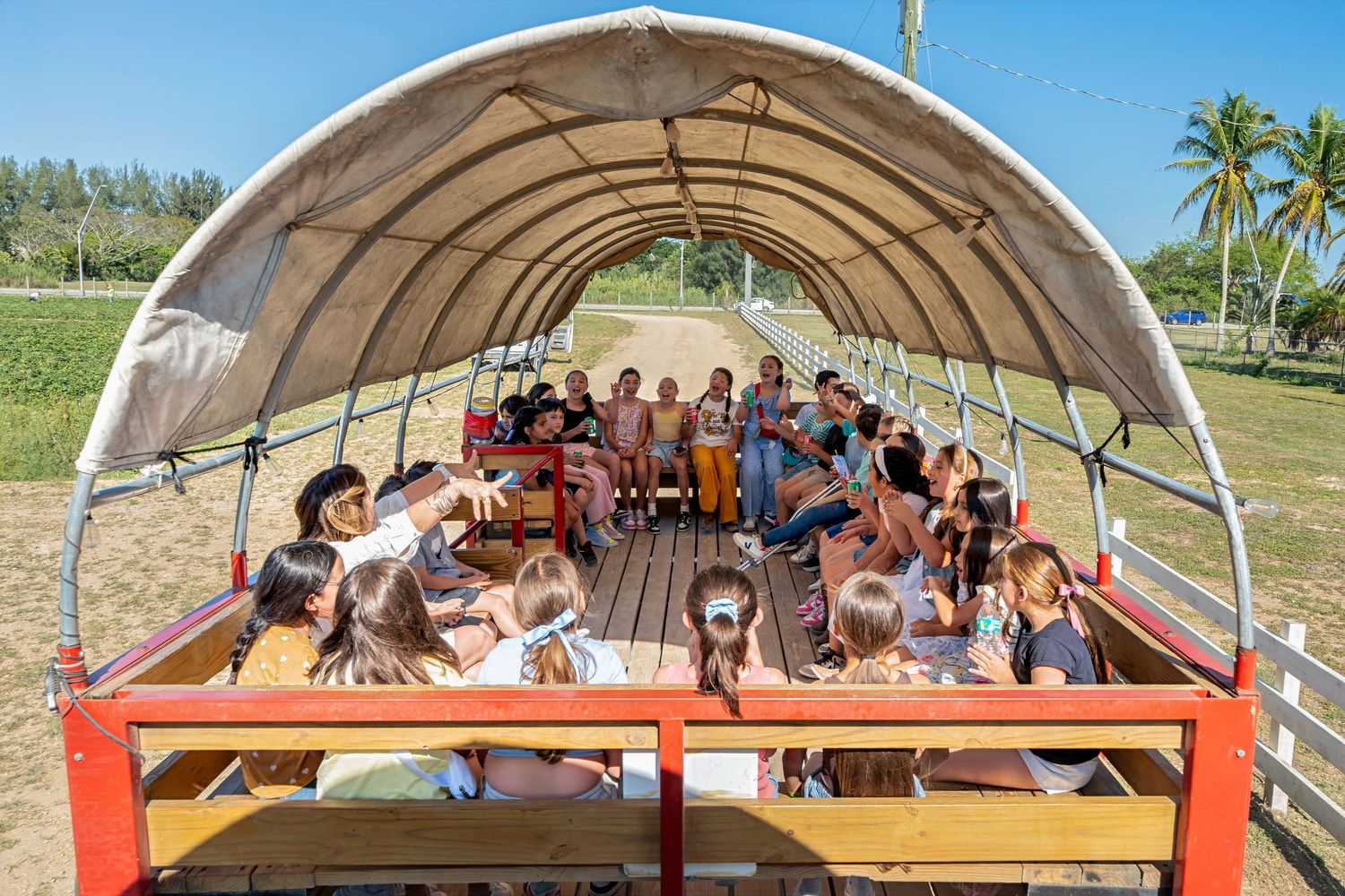 Wagon ride through the farm during South Florida birthday party at Berry Farms.