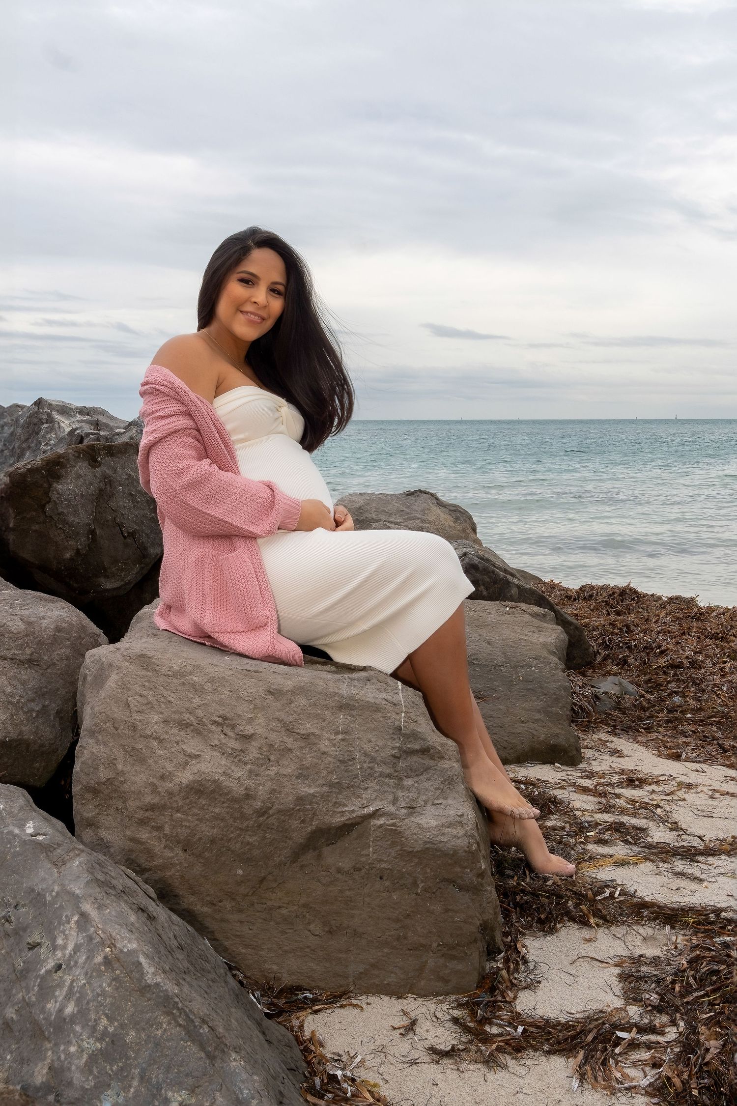 Elegant maternity session in Key Biscayne, capturing a peaceful moment as a mother-to-be embraces the coastal breeze.