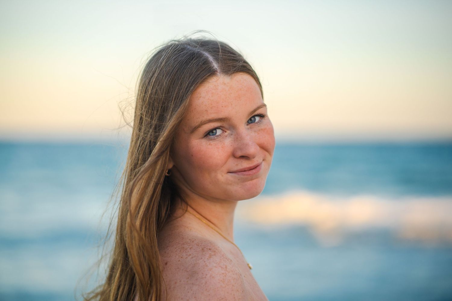Senior beach portraits in South Florida by photographer, natural light close-up with ocean backdrop at sunset