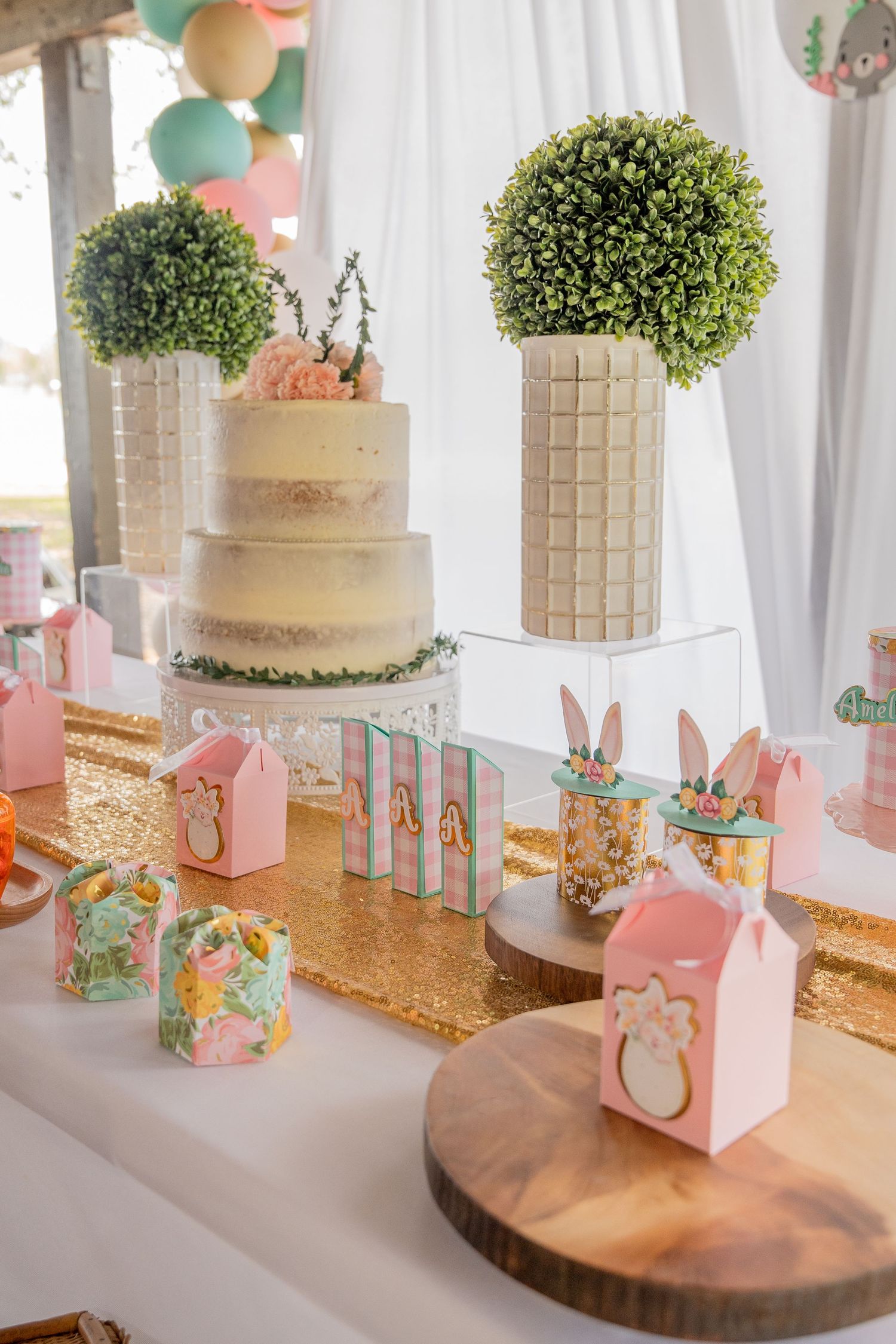 Styled dessert table with cake and party favors at a South Florida baby shower.