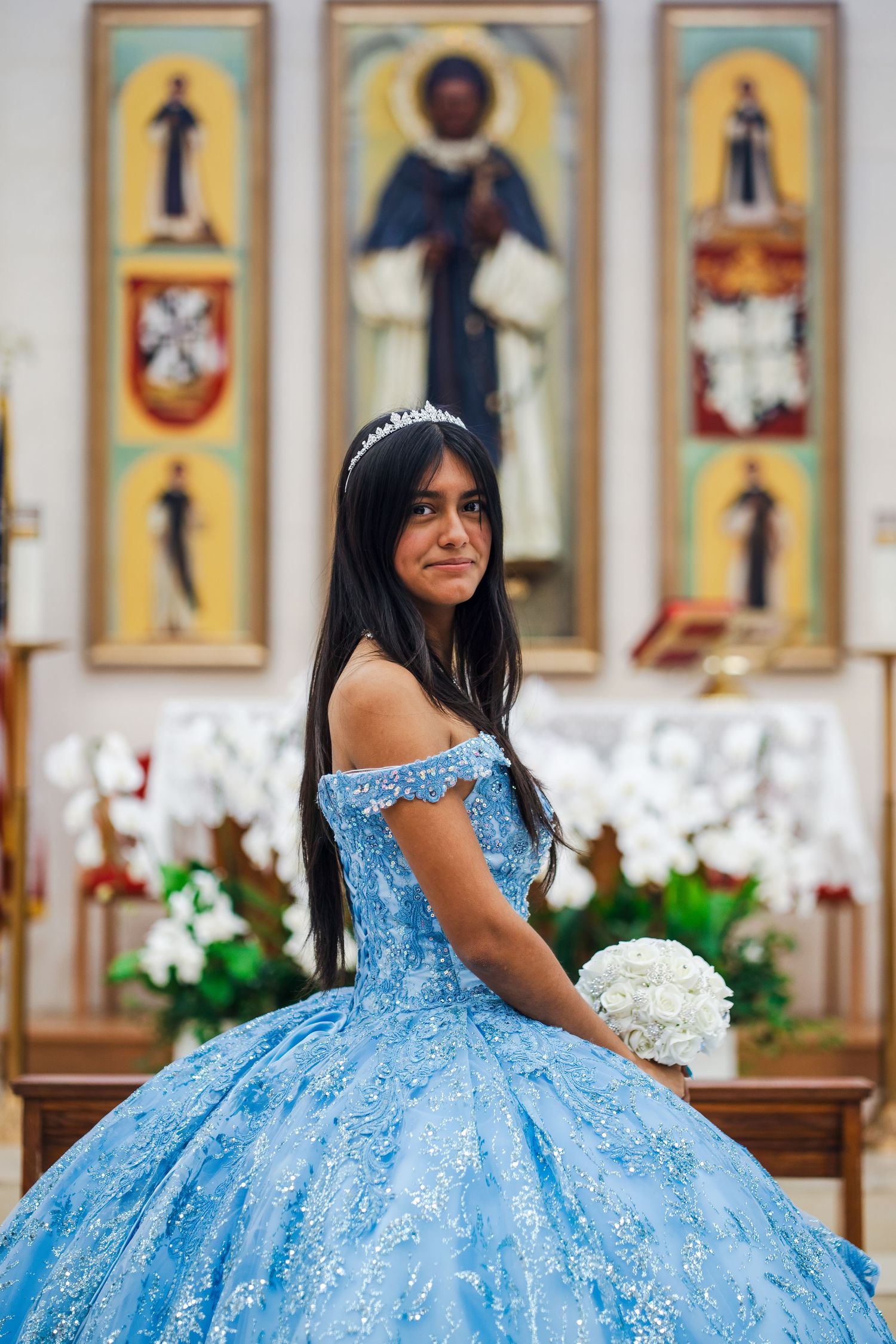 Quinceañera in blue ball gown during church ceremony captured through a guided event photography experience in South Florida