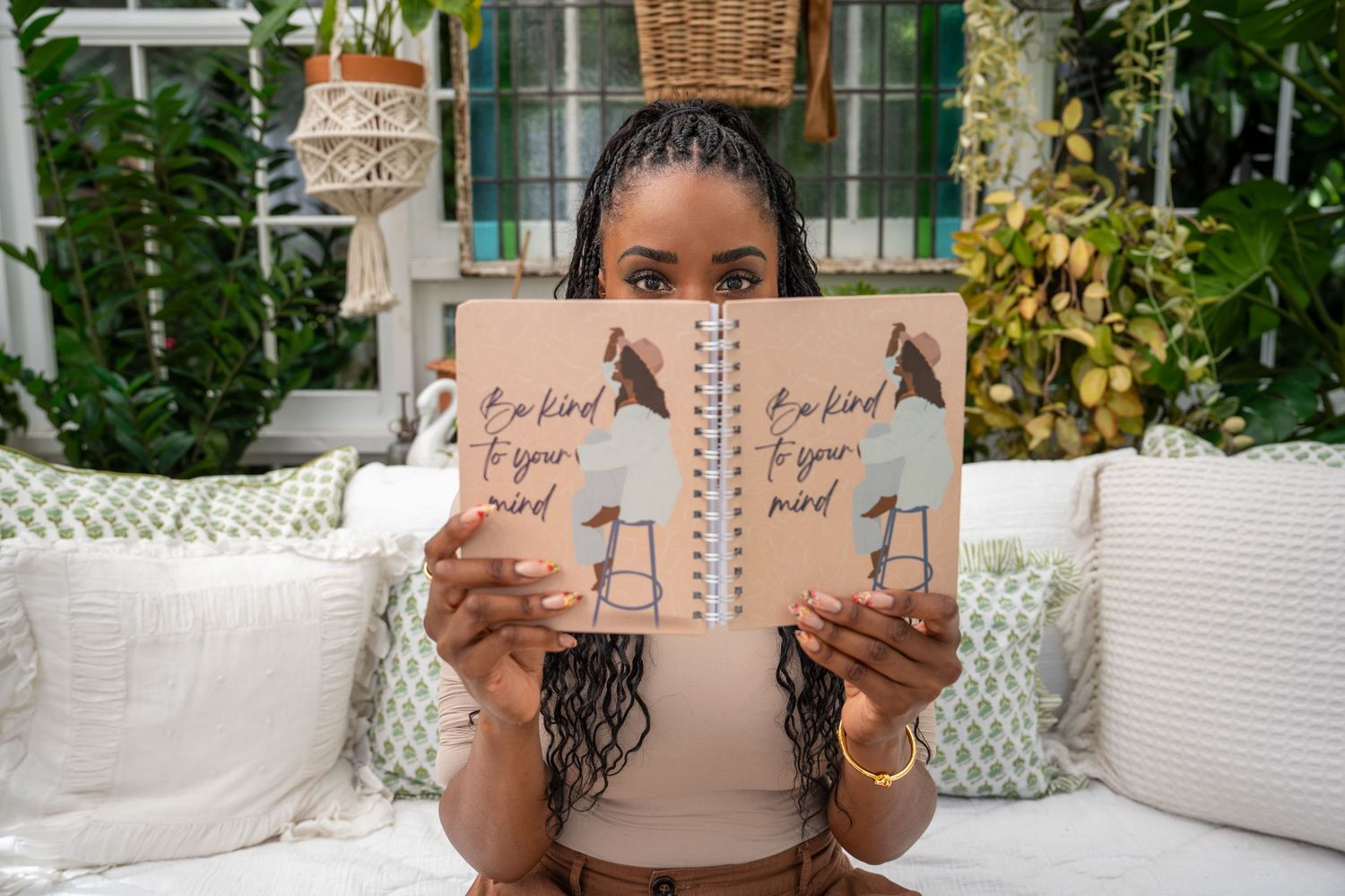 South Florida branding photography of woman holding illustrated books in a modern studio with greenery
Weston Photographer