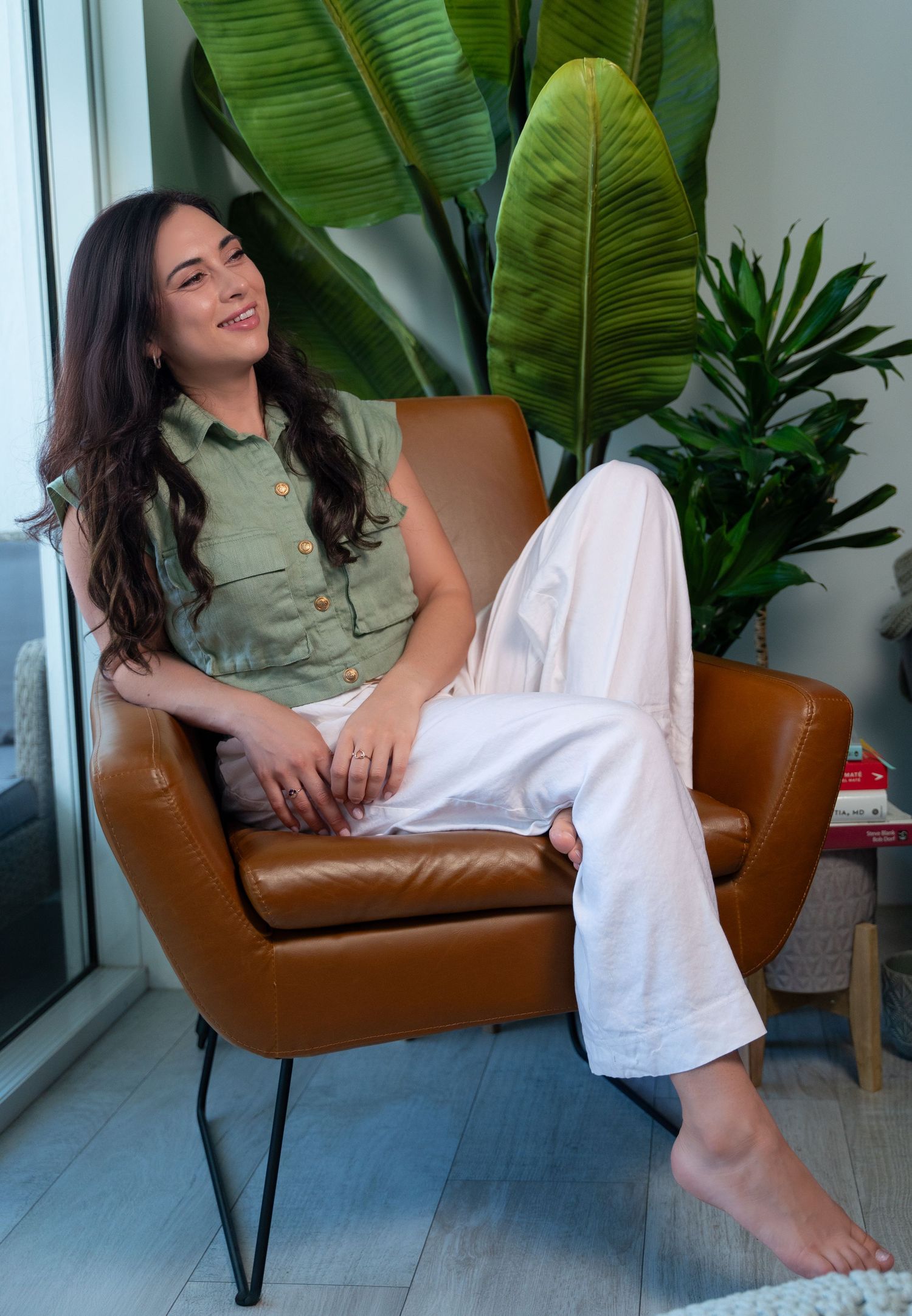 Modern workspace branding shoot in West Palm Beach, FL – laid-back portrait in a plant-filled office setting.