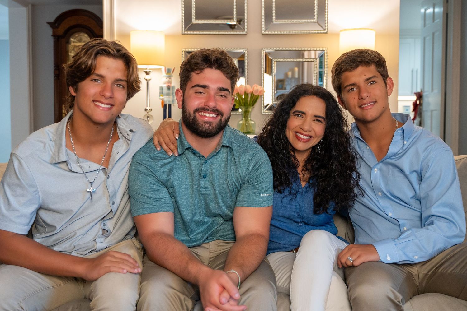 Casual indoor family portrait in Boca Raton, FL – siblings and friends sharing a joyful moment on the couch.