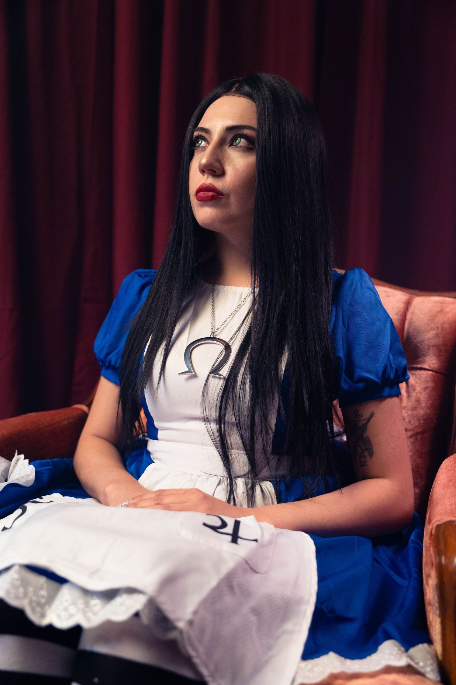 Horror-inspired Alice in Wonderland shoot in Fort Lauderdale, FL – eerie cosplay portrait with moody blue and red lighting.