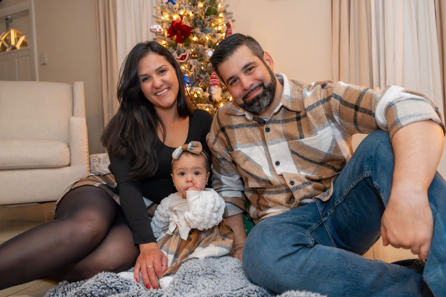 Festive Christmas family photoshoot in Fort Lauderdale, FL – joyful holiday moment with warm lighting and cozy decor.