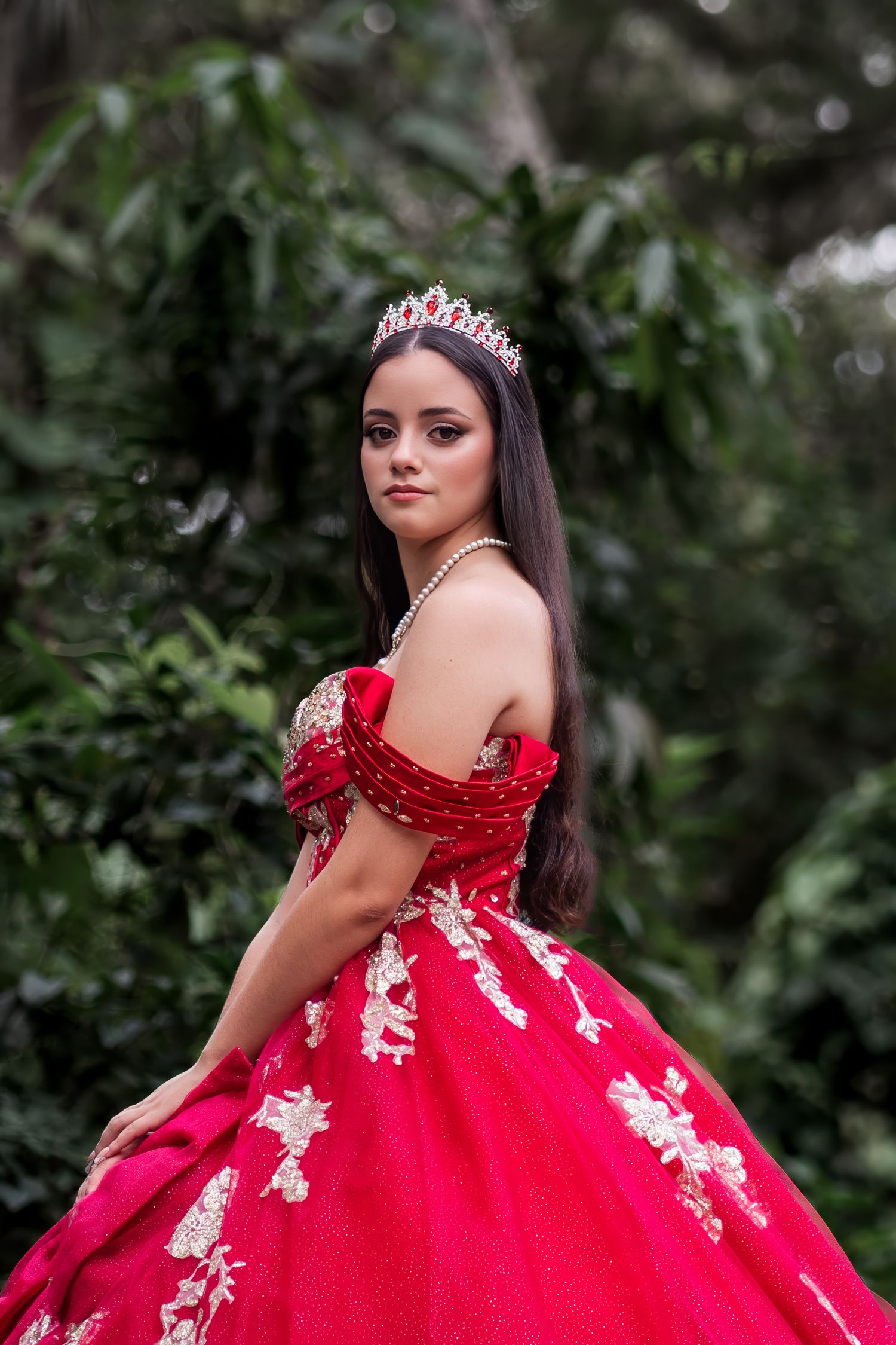 Miami quinceañera portrait of young woman in vibrant red gown outdoors