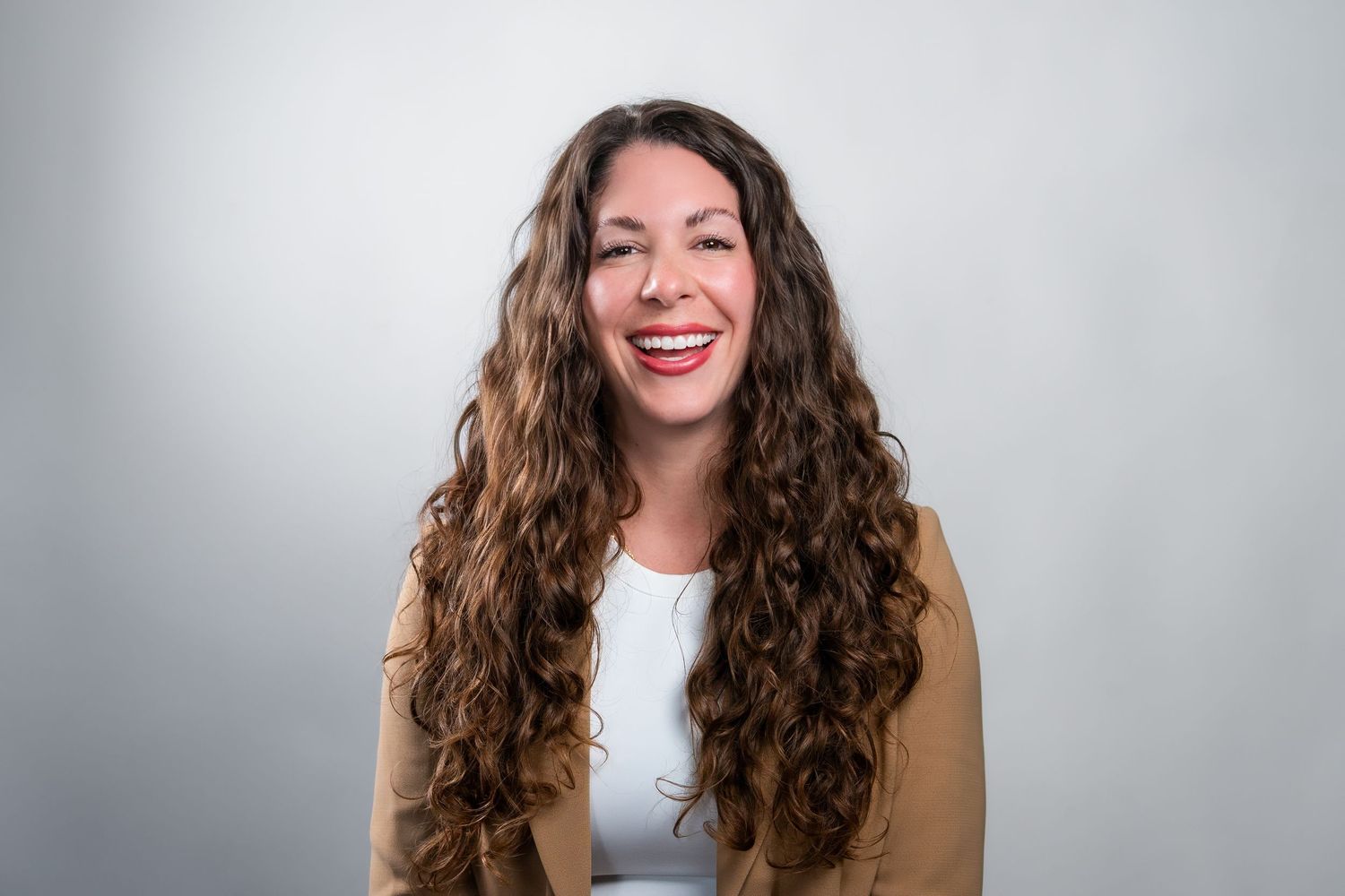 Miami headshot photography of woman in beige blazer smiling in studio setting

Coral Springs Photographer