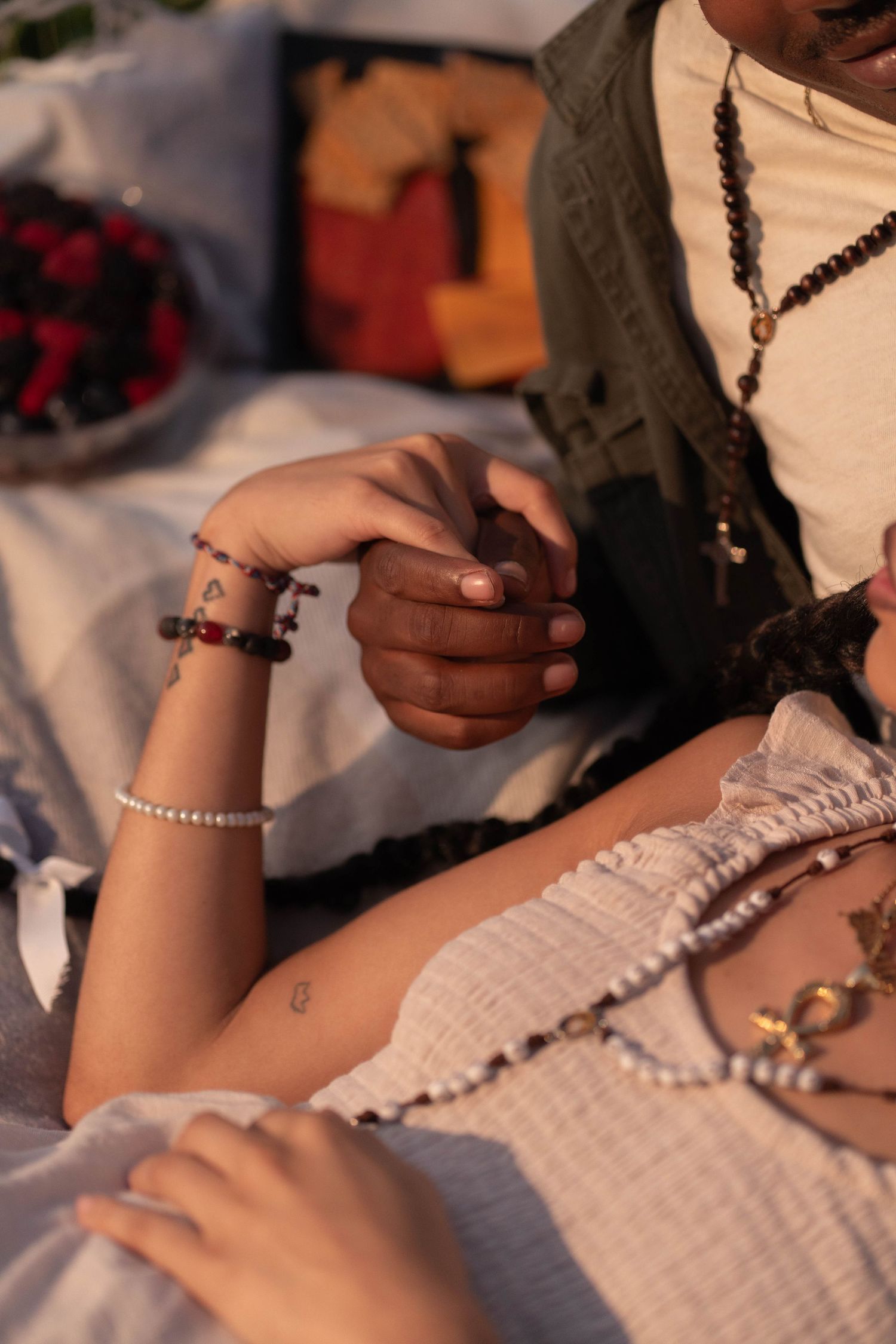 Elegant detail shot of intertwined hands, capturing love and intimacy during a Fort Lauderdale picnic session.