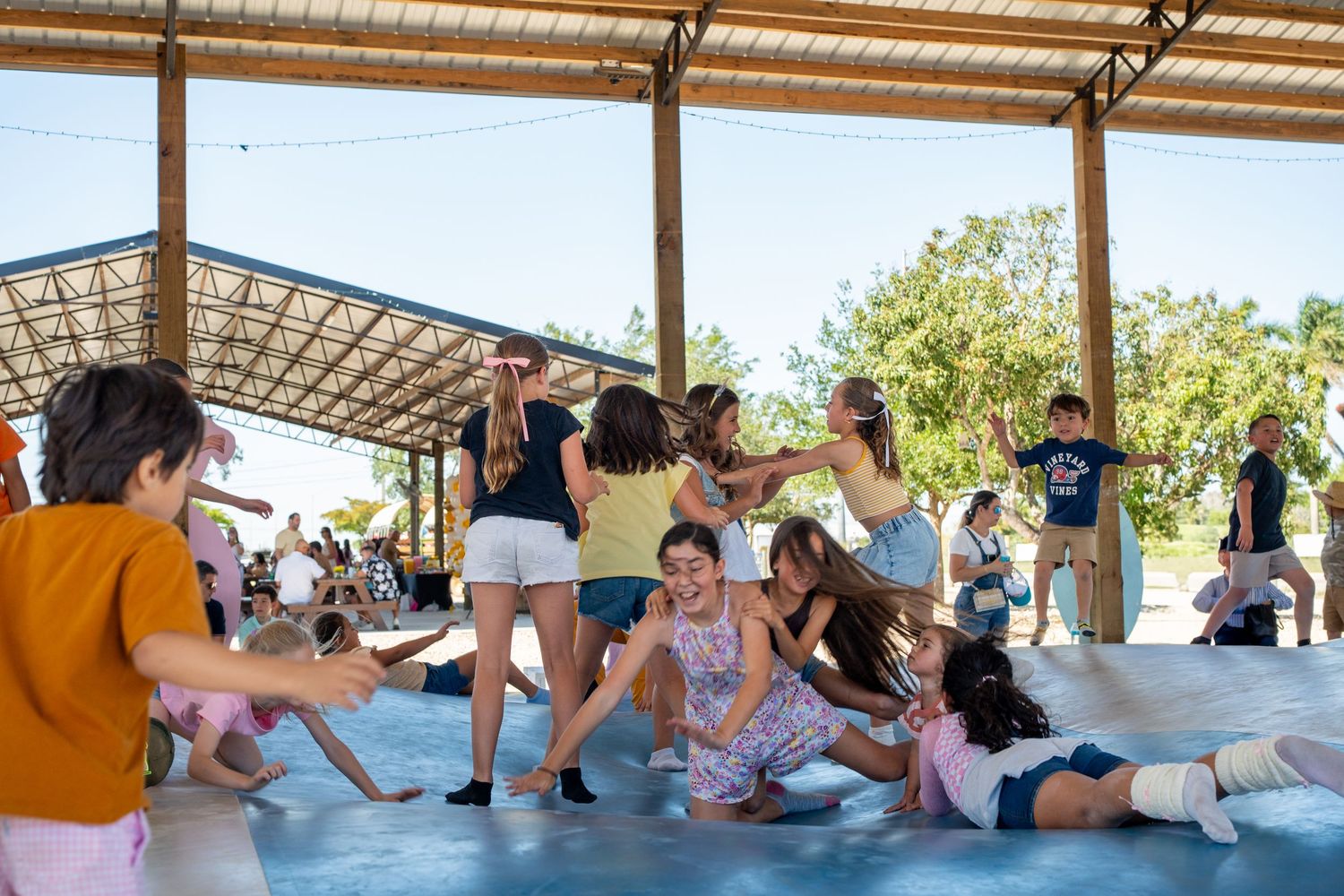 Kids playing at a birthday party at Berry Farms, candid event photography in South Florida.