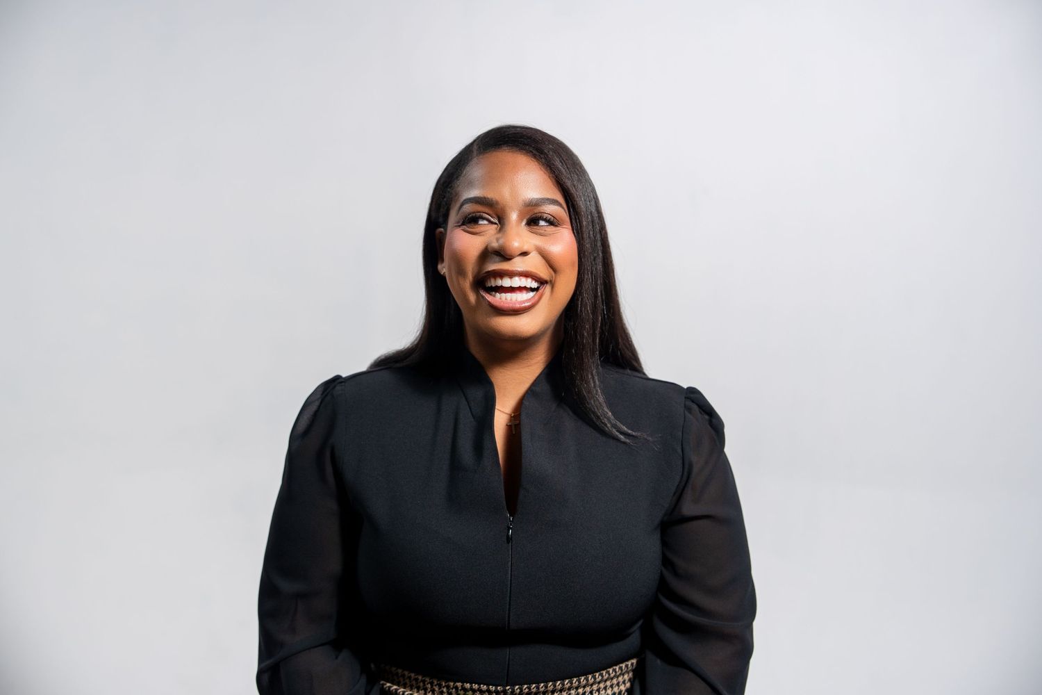 Professional branding headshot of a scholarship coach smiling during a studio branding session.