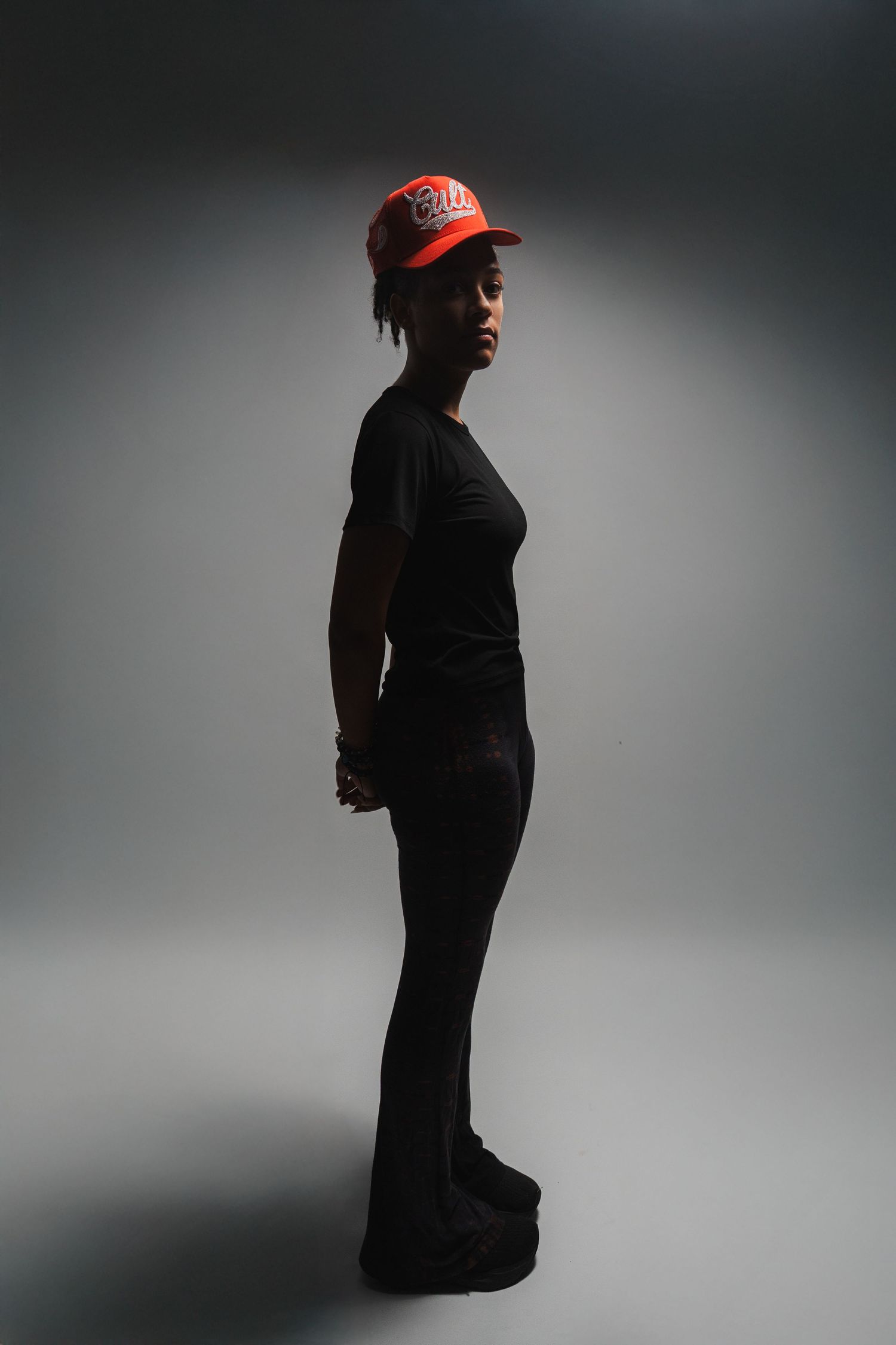 Studio senior photos in South Florida by photographer, minimal side profile portrait with dramatic lighting and clean backdrop
