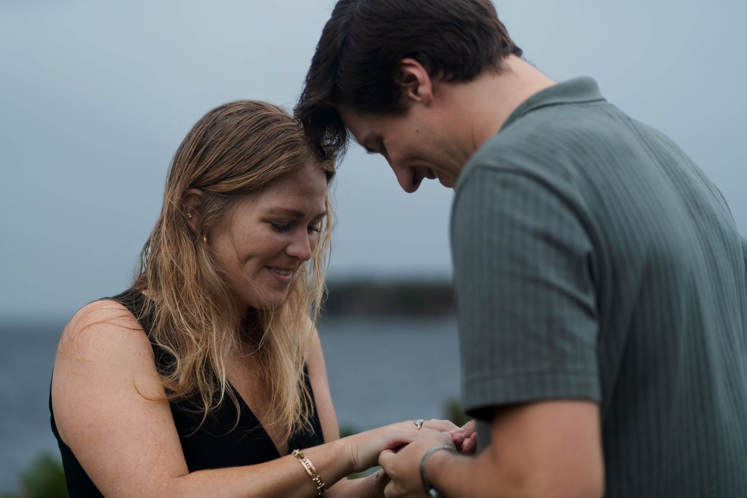 ntimate proposal moment as he slips the ring onto her finger, with a scenic waterfront view at The Kampong in Miami.