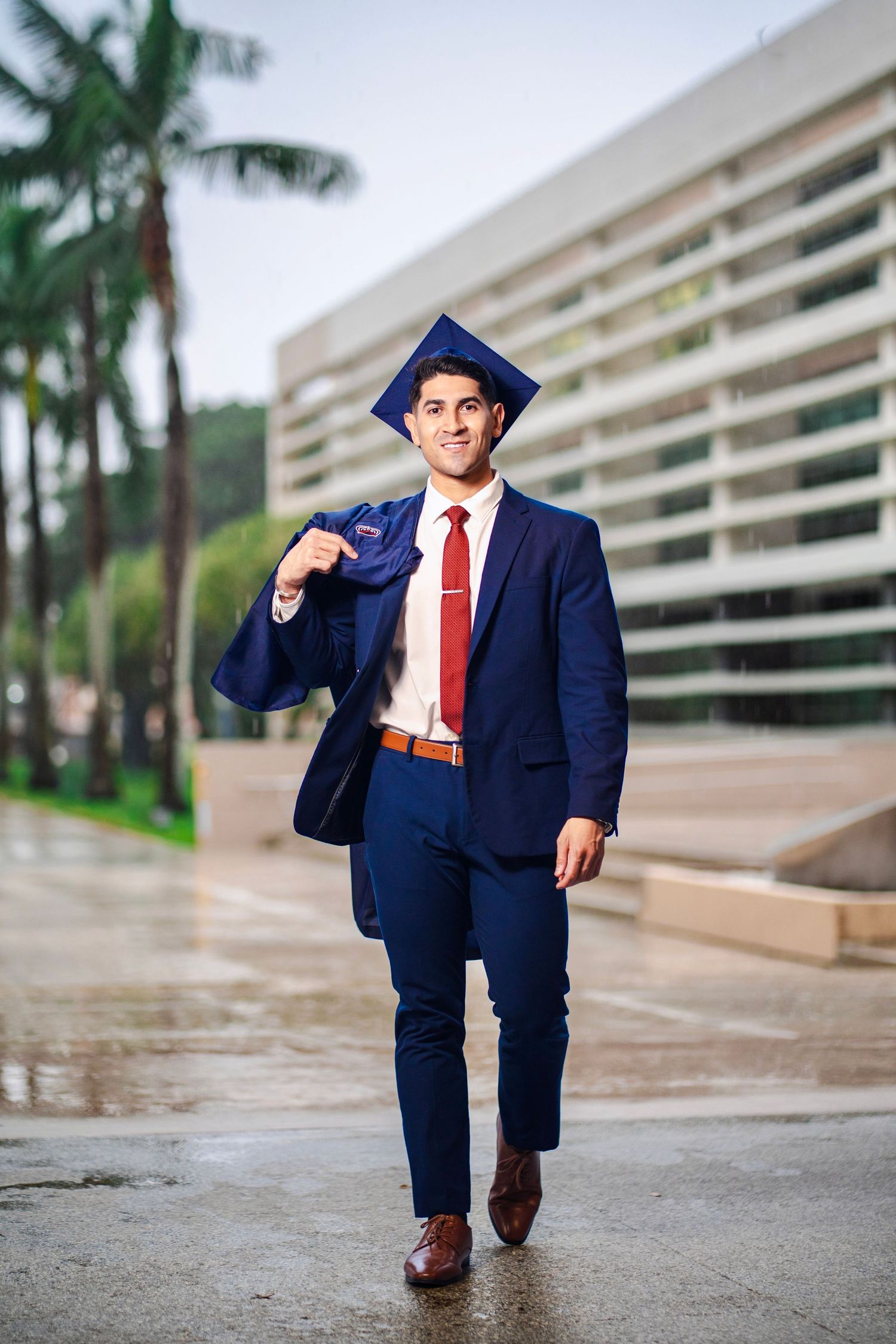 Close-up graduation portrait of an FAU graduate in cap and gown during a Boca Raton senior session.