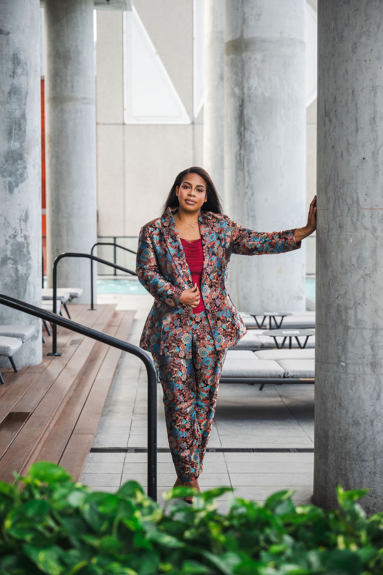 Lifestyle branding portrait of an entrepreneur standing between architectural columns during a South Florida session.