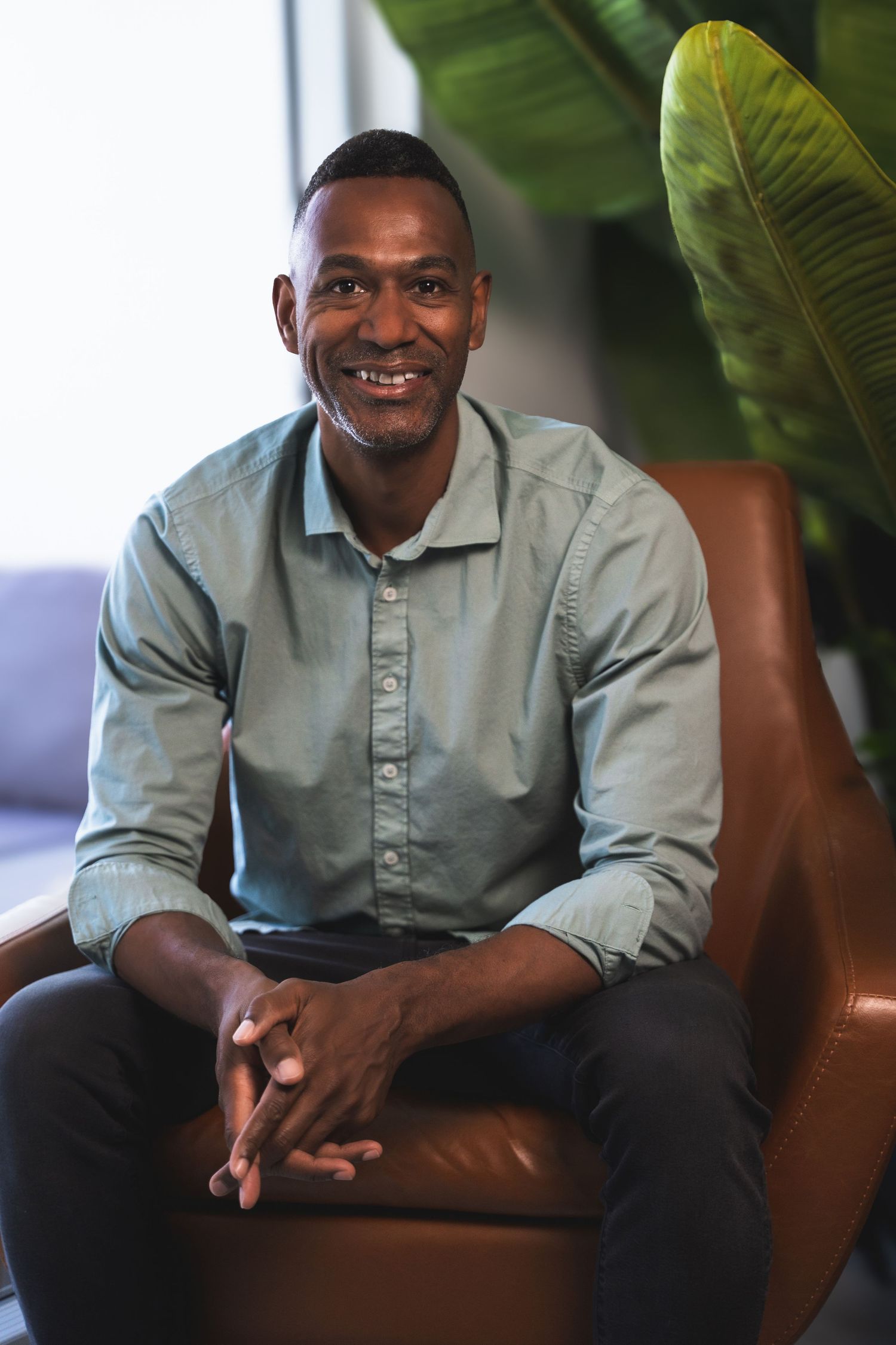 Professional headshot in Fort Lauderdale, FL – relaxed and approachable portrait in a stylish office setting.